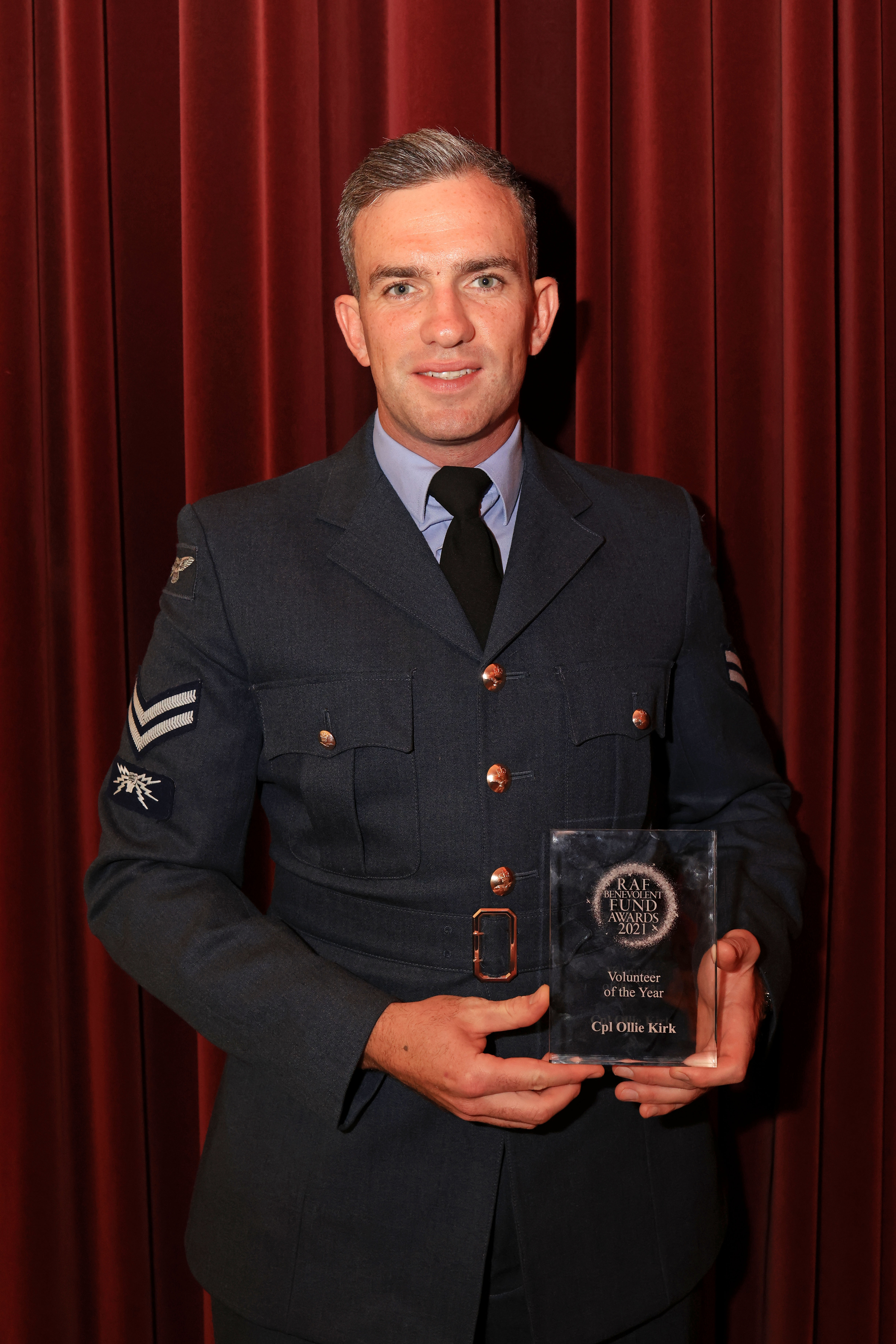 Ollie holds his award.