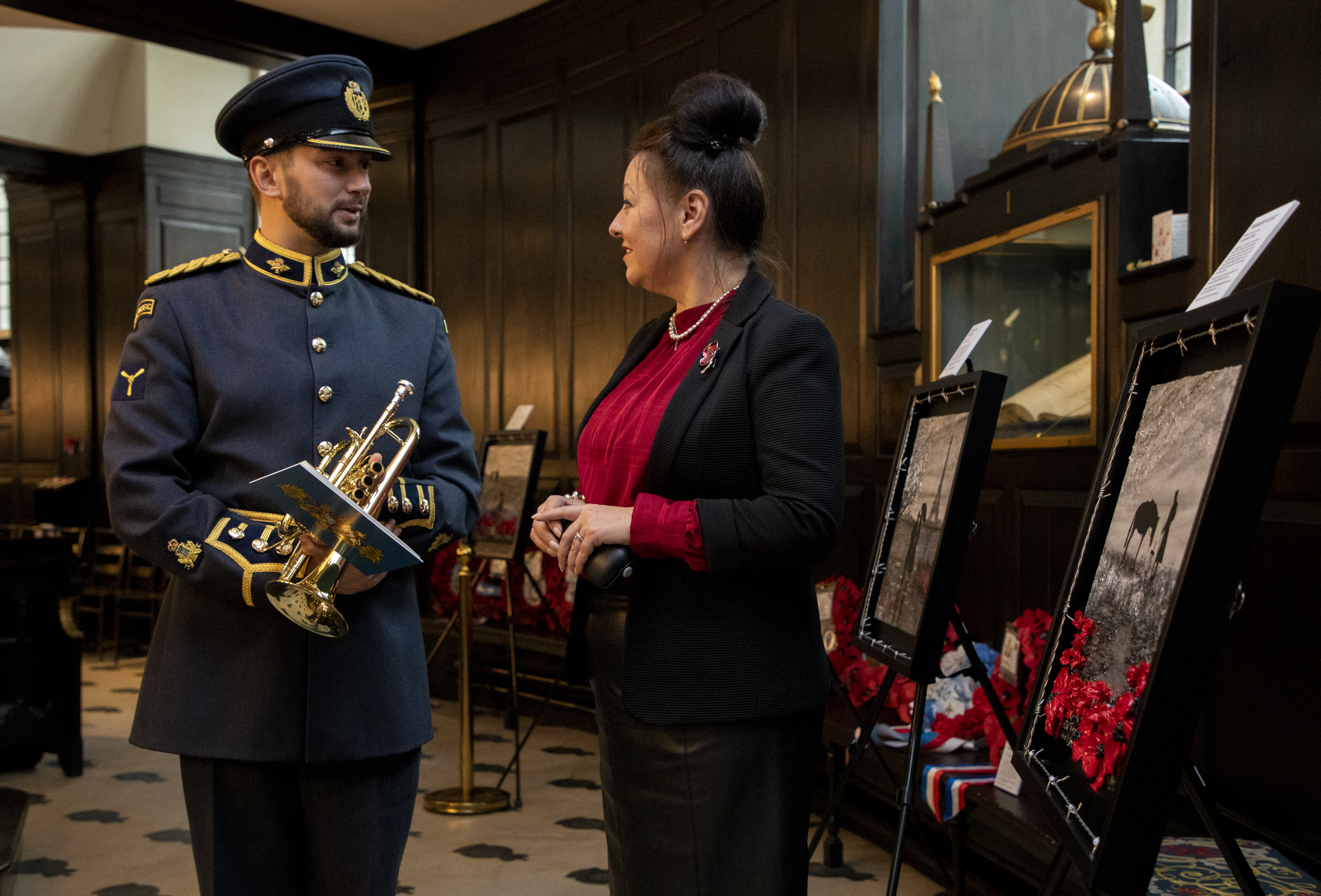 Image shows RAF aviator with artist inside St Clement Danes church.