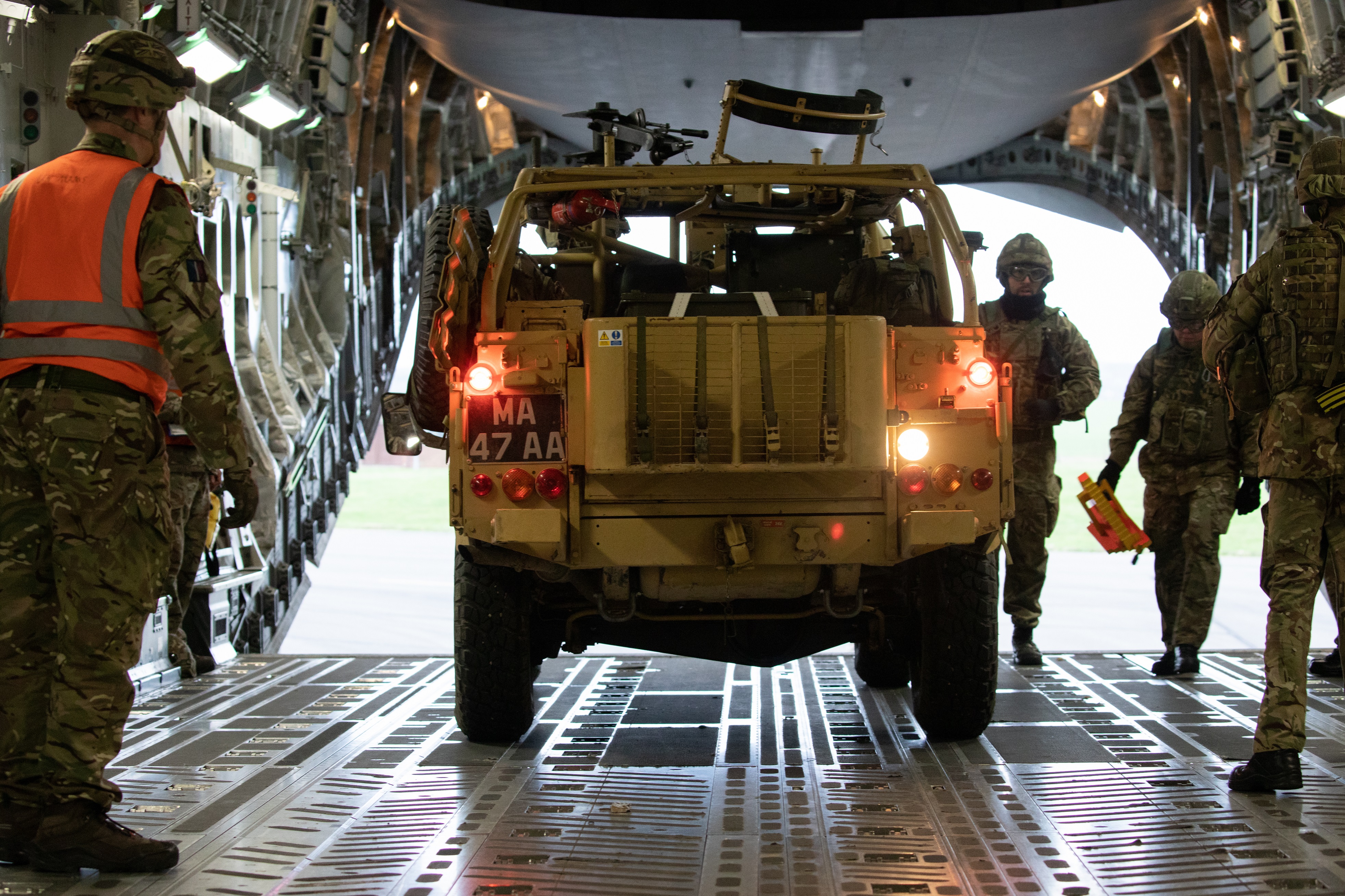 Personnel from No 1 Air Mobility Wing loading personnel and equipment from No 16 Air Assault Brigade onto a 99 Squadron RAF C-17