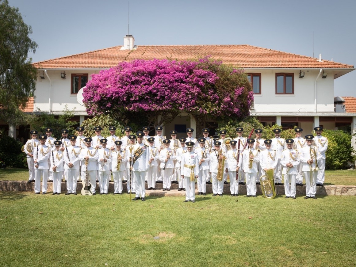 Image shows RAF Music Band standing outside a House.