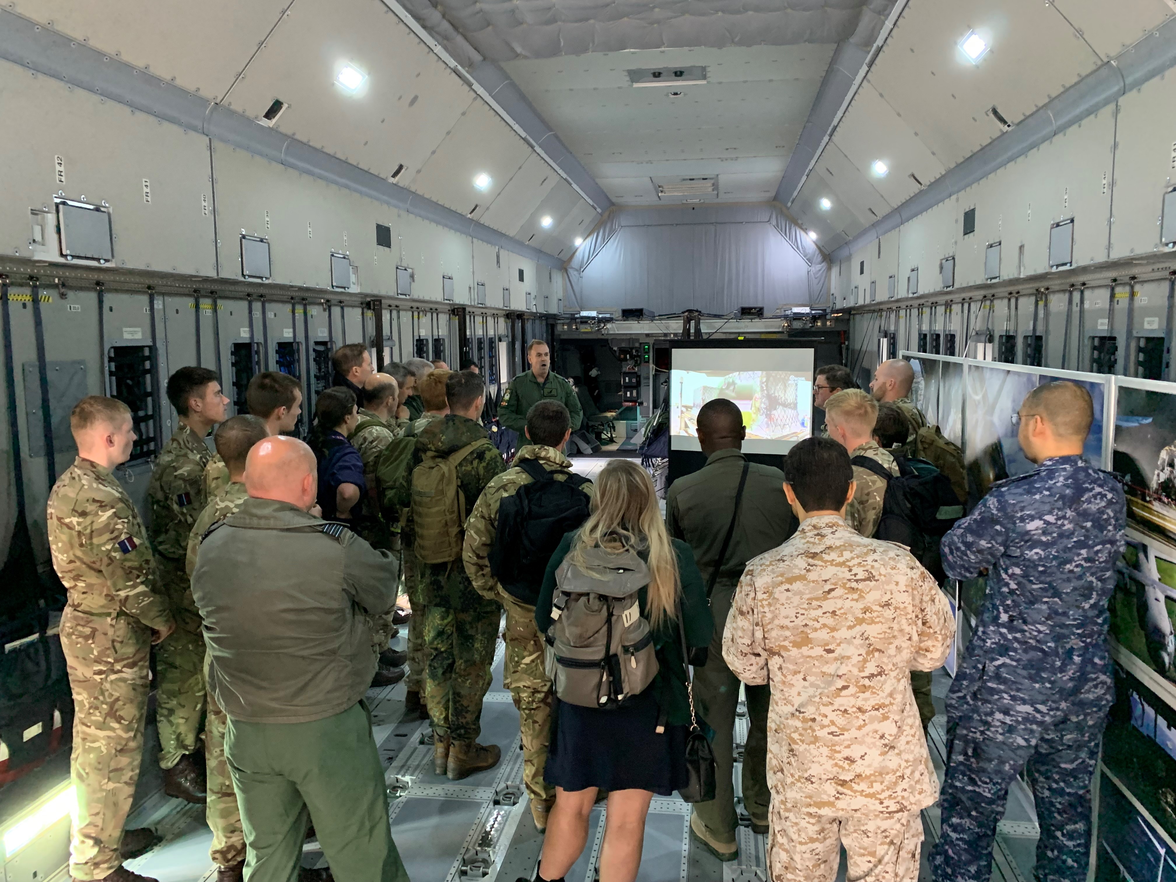 Aviators and personnel stand gathered for presentation/