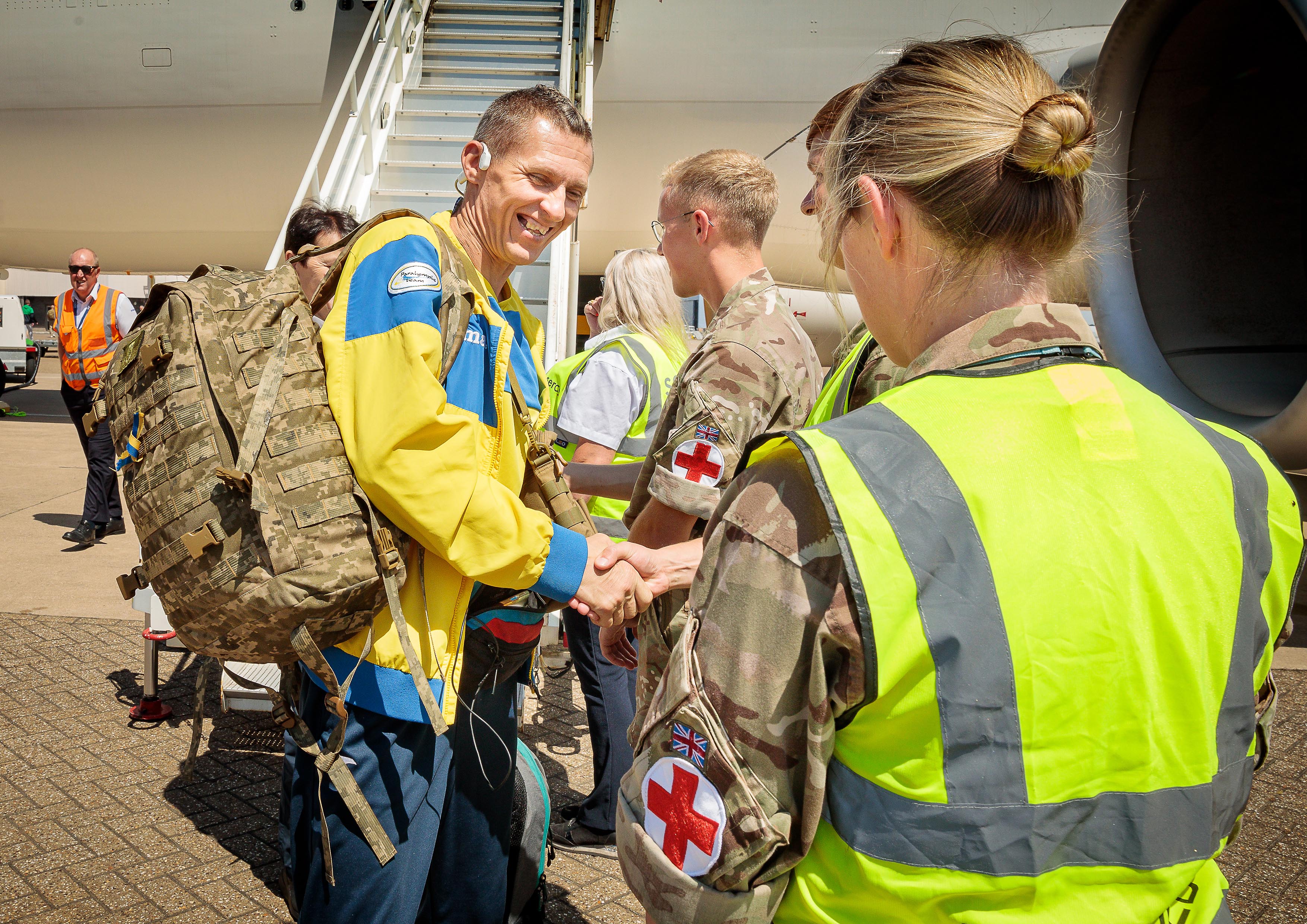Image shows aviators shaking hands on the airfield.