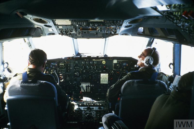 Aged image of Aviators inside a cockpit.