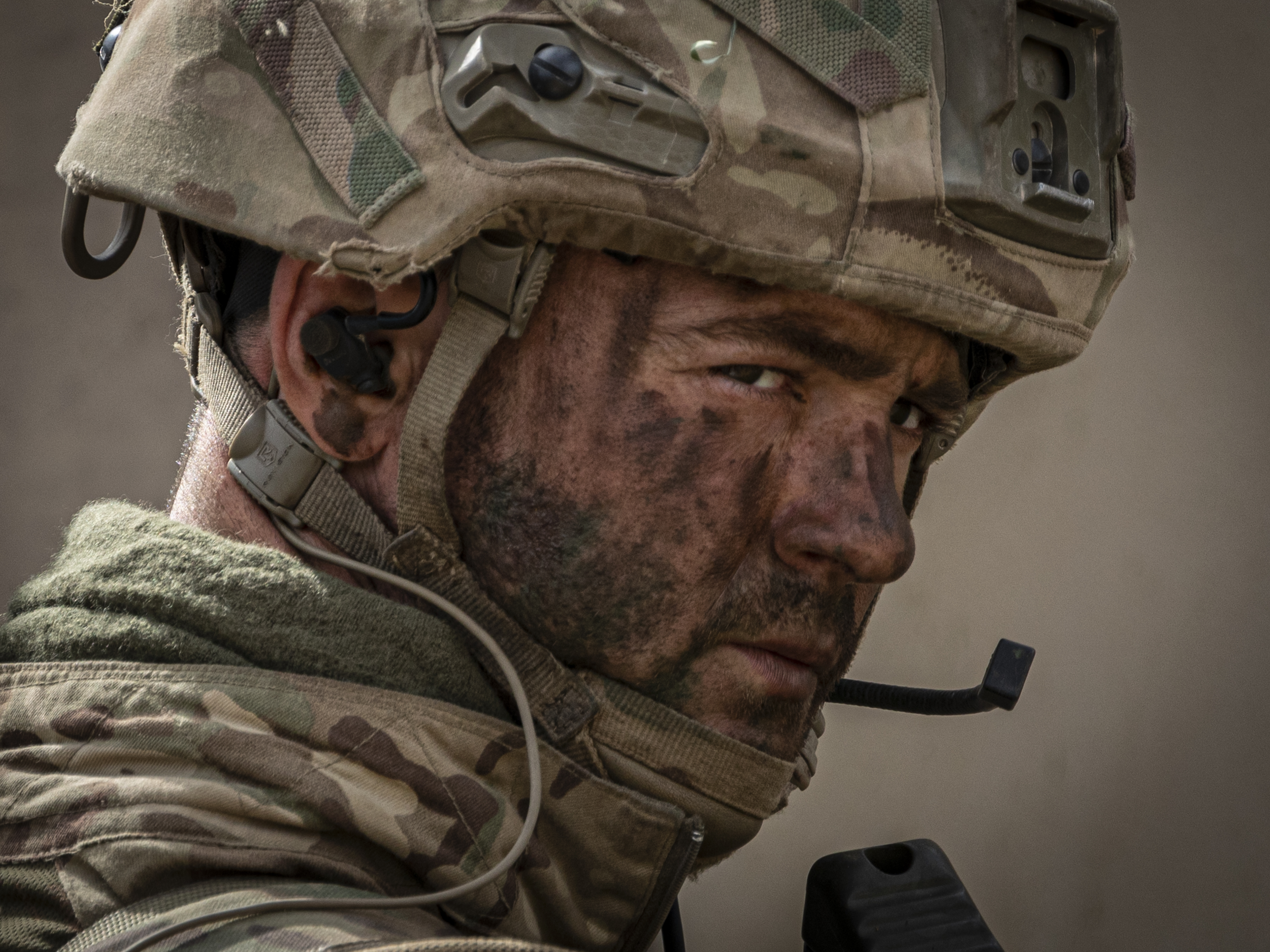 Image shows close head shot of RAF Regiment wearing helmet.