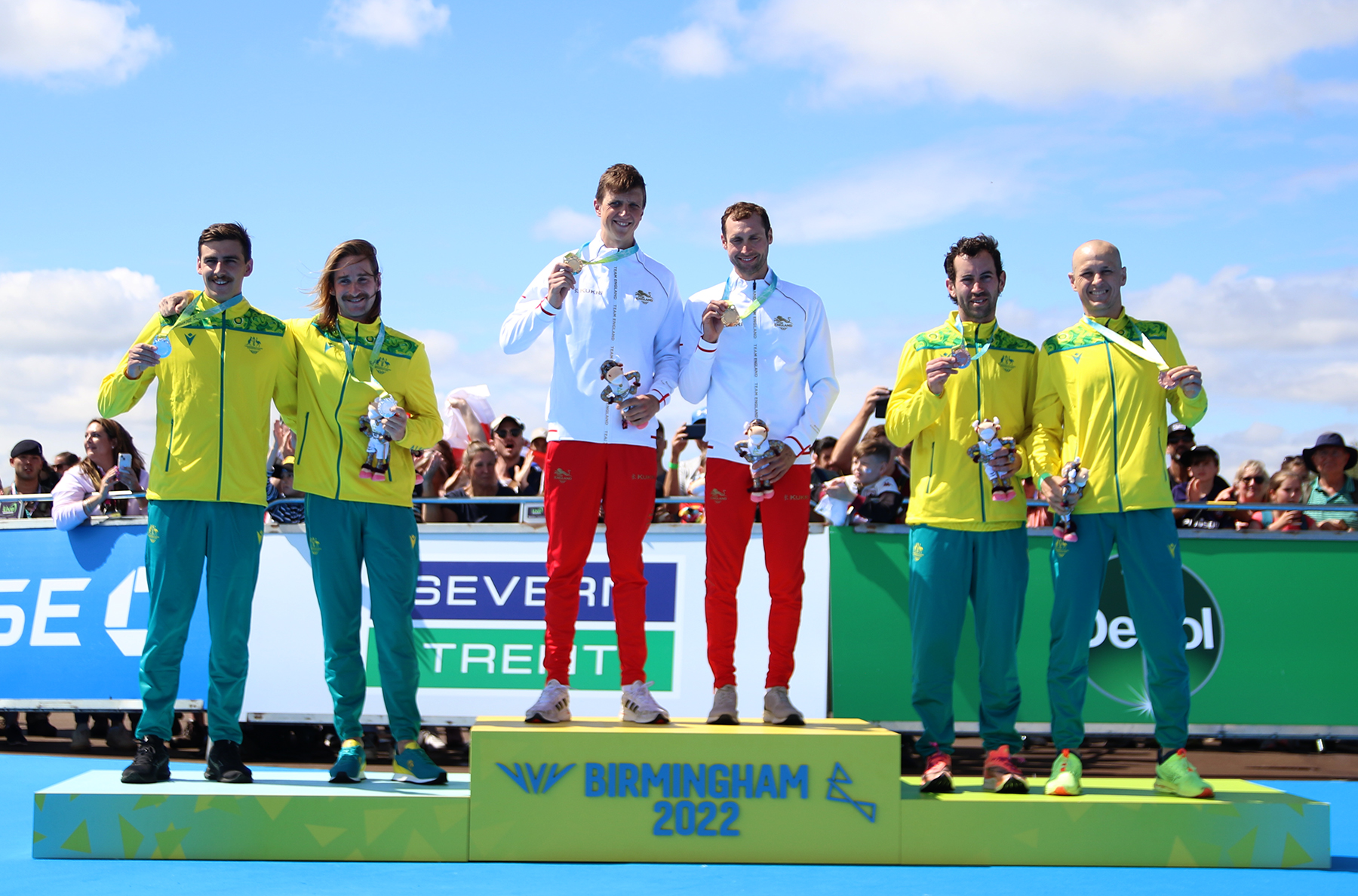 Image shows sportsmen on tiered dais. 