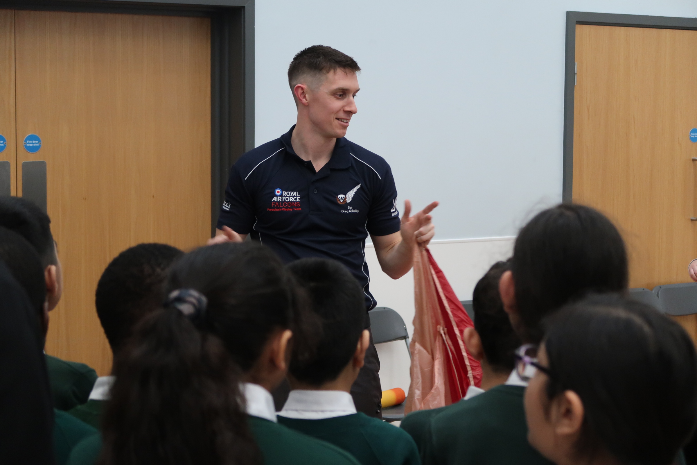 Members of the Royal Air Force Falcons Parachute Display Team have visited a primary school in the West Midlands during a break in their display training.