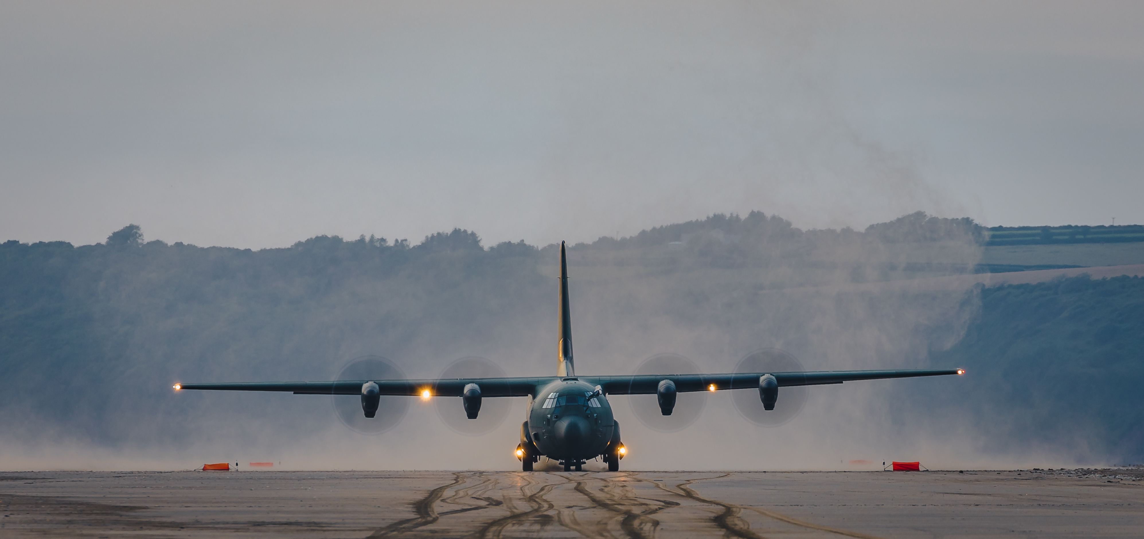 Image shows Hercules aircraft on the beach.