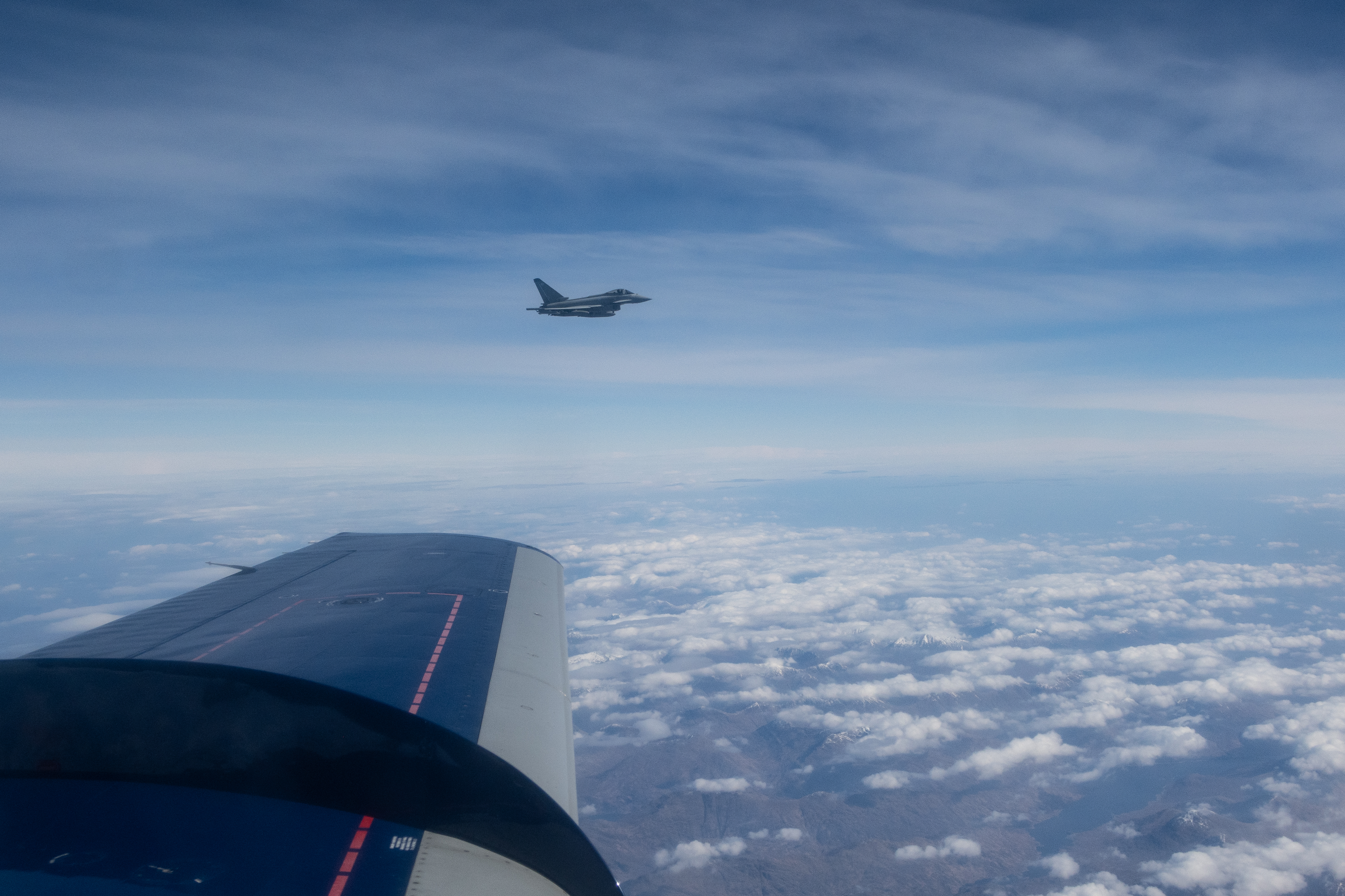 Typhoon in flight, with aircraft wing in shot.