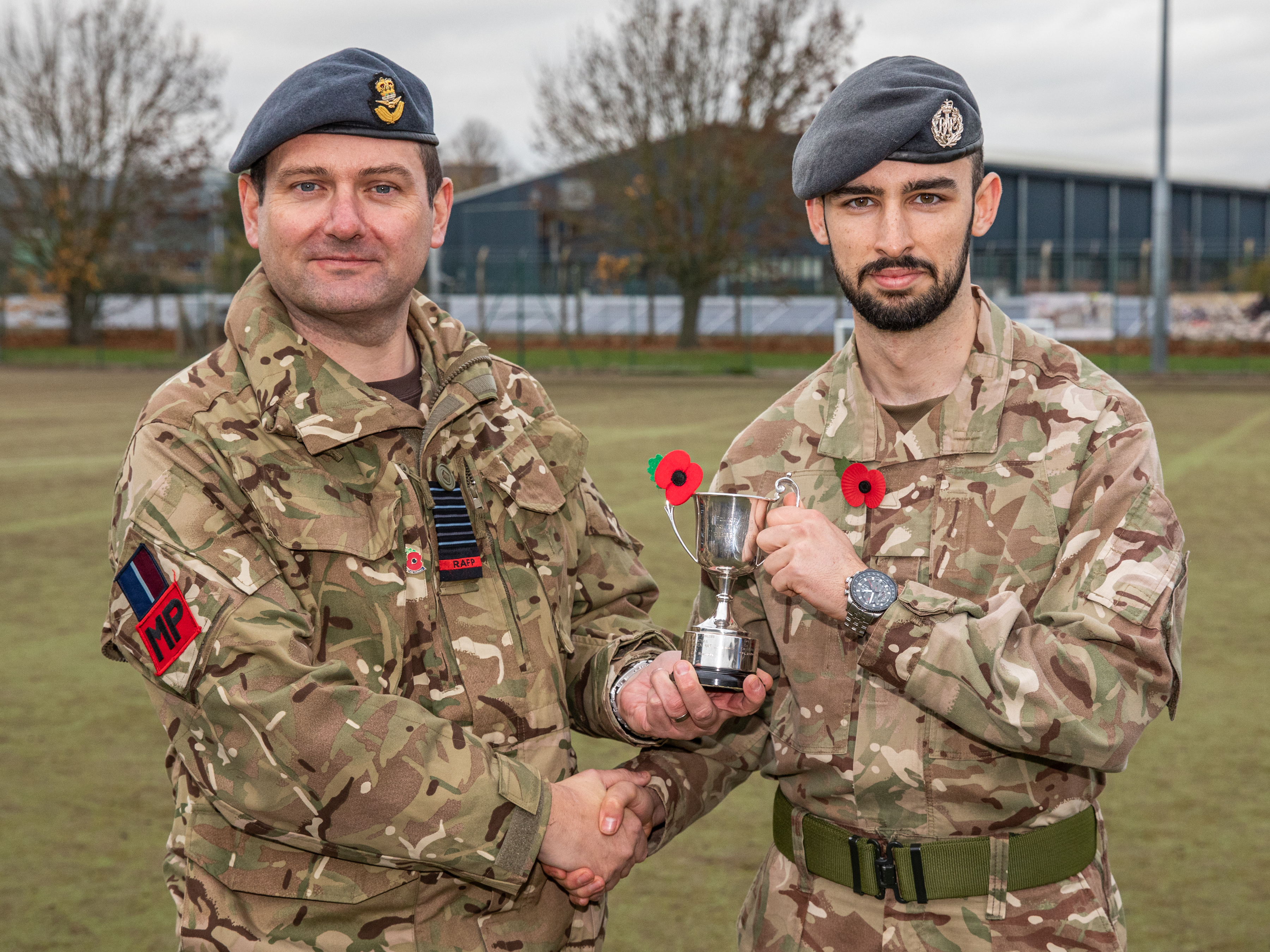 Image shows RAF Police shaking hands and accepting award.