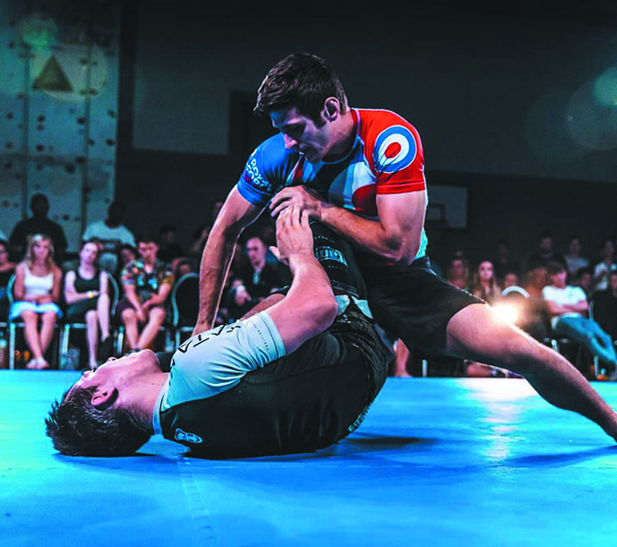 Jon and opponent on the Jiu Jitsu mat.