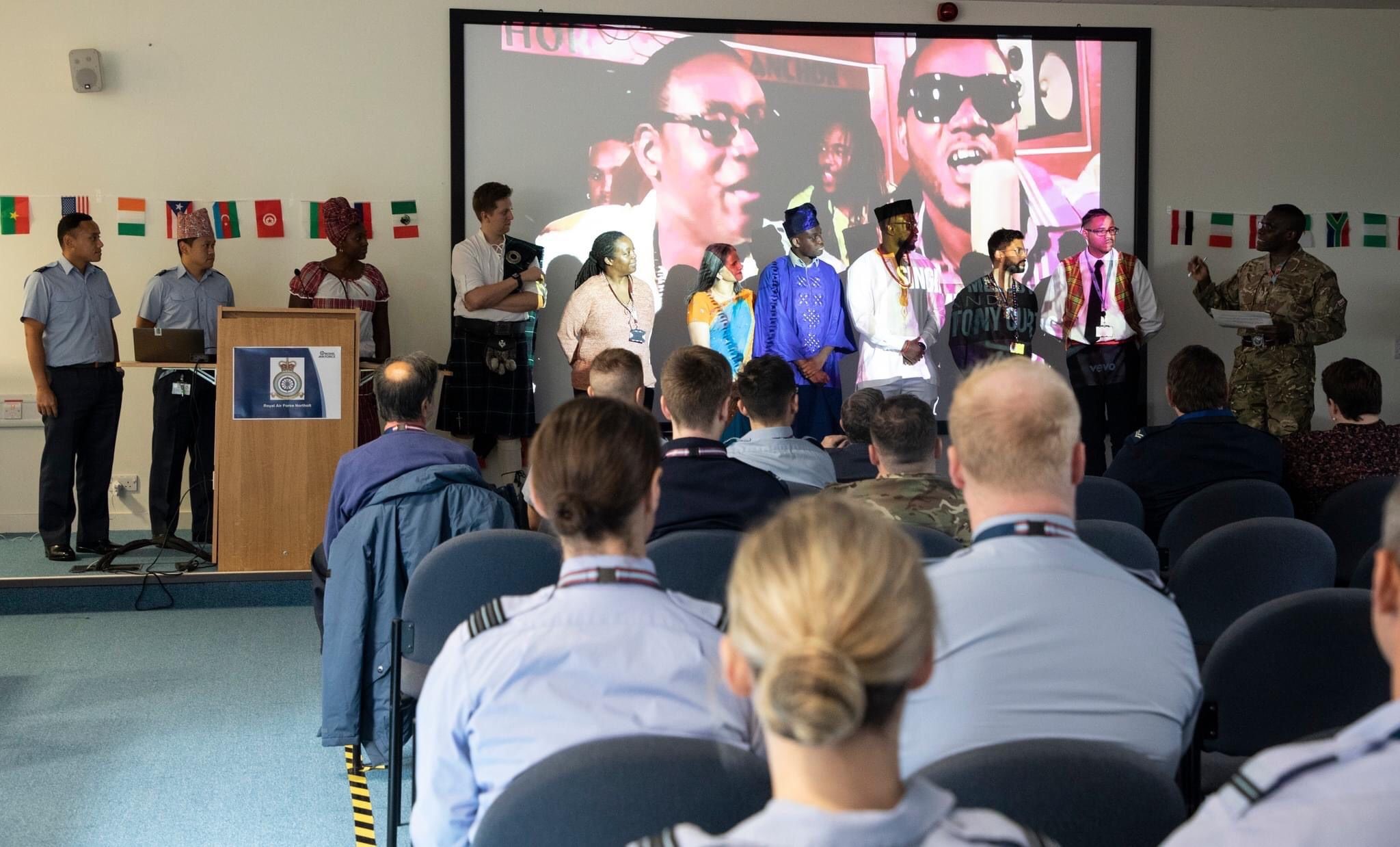 Image shows RAF aviators in the seated audience of a presentation room.