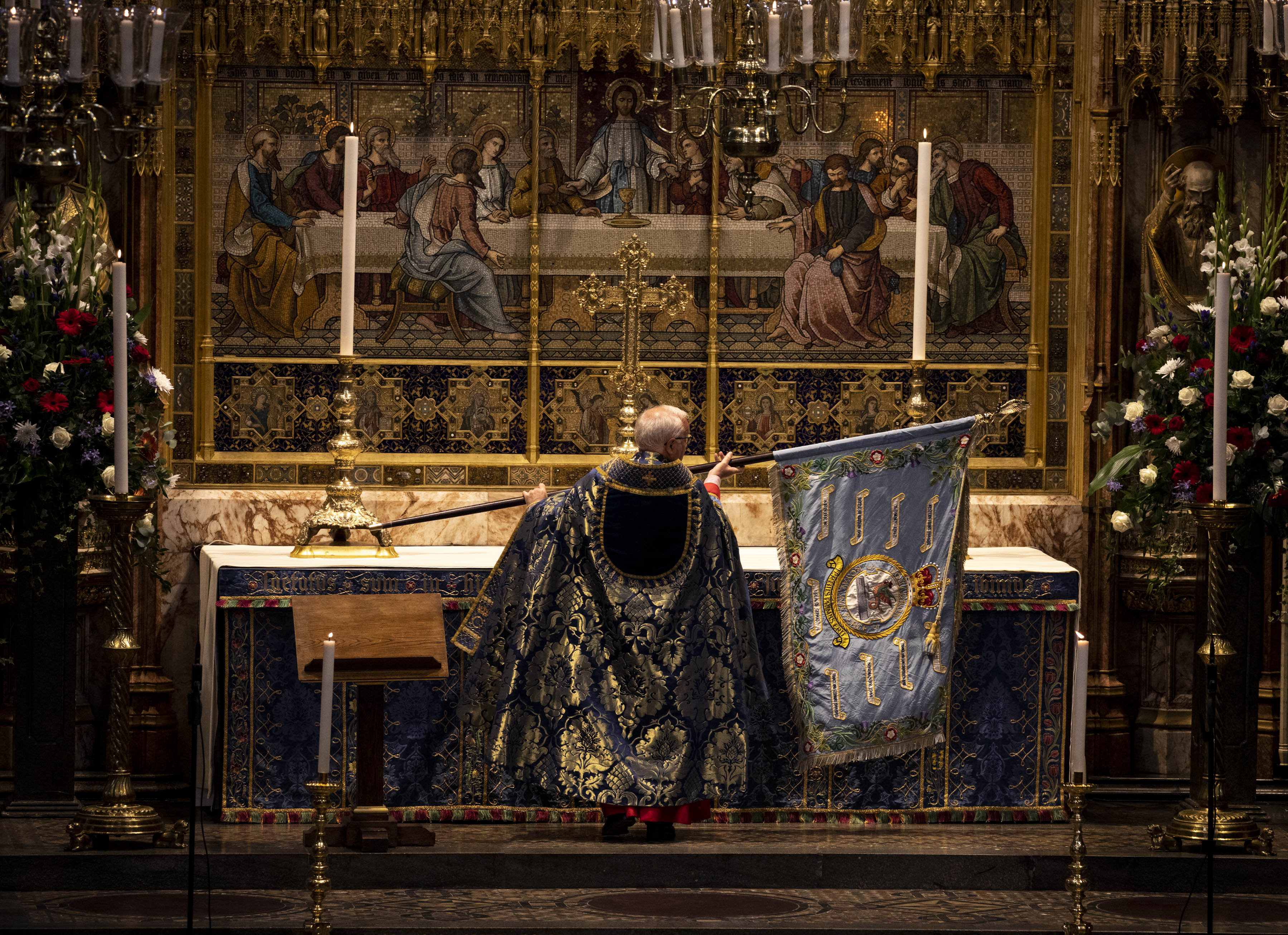 Inside Westminster Abbey as the Dean waves a flag.