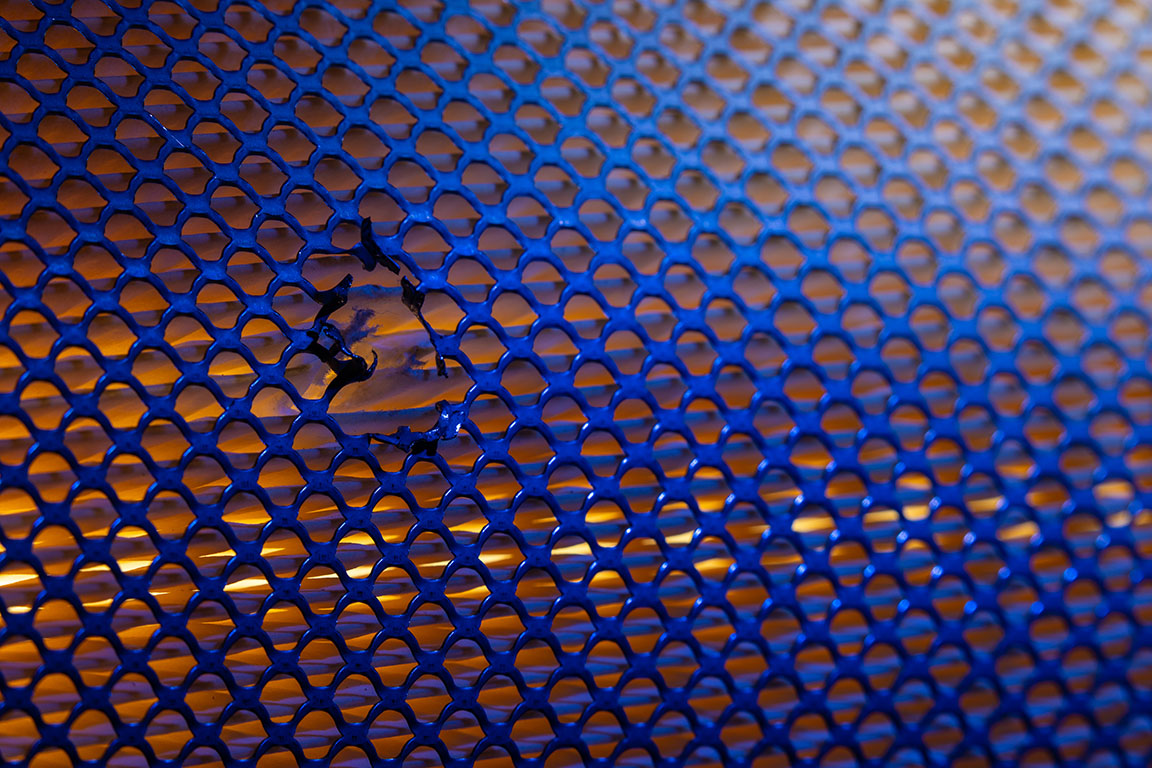 Image shows close up of a mesh netting around a filter.