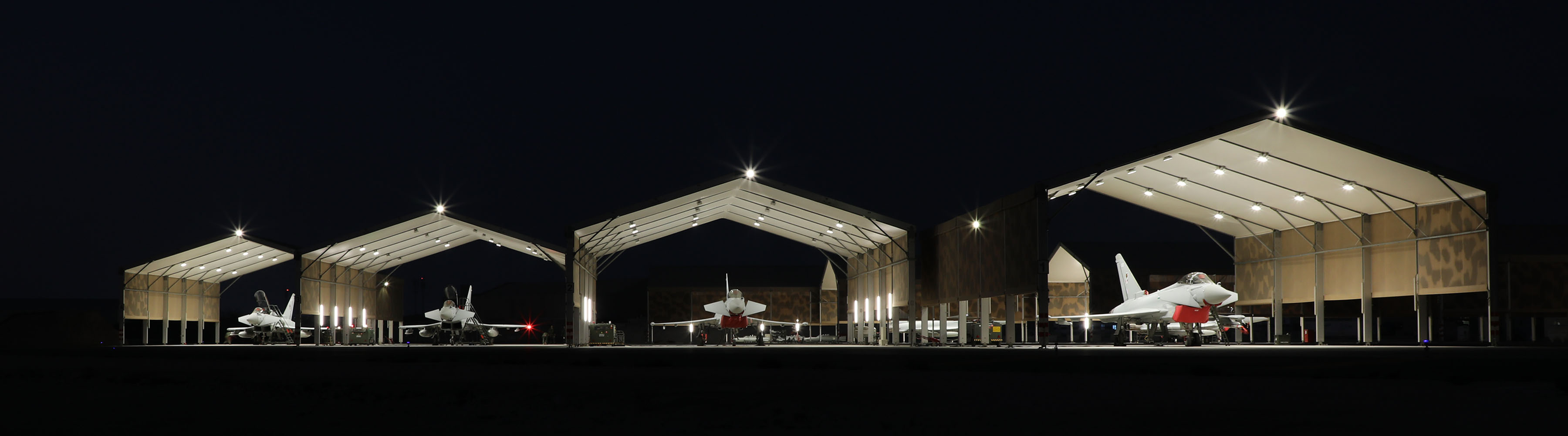 Four Typhoons in the hangars at night.