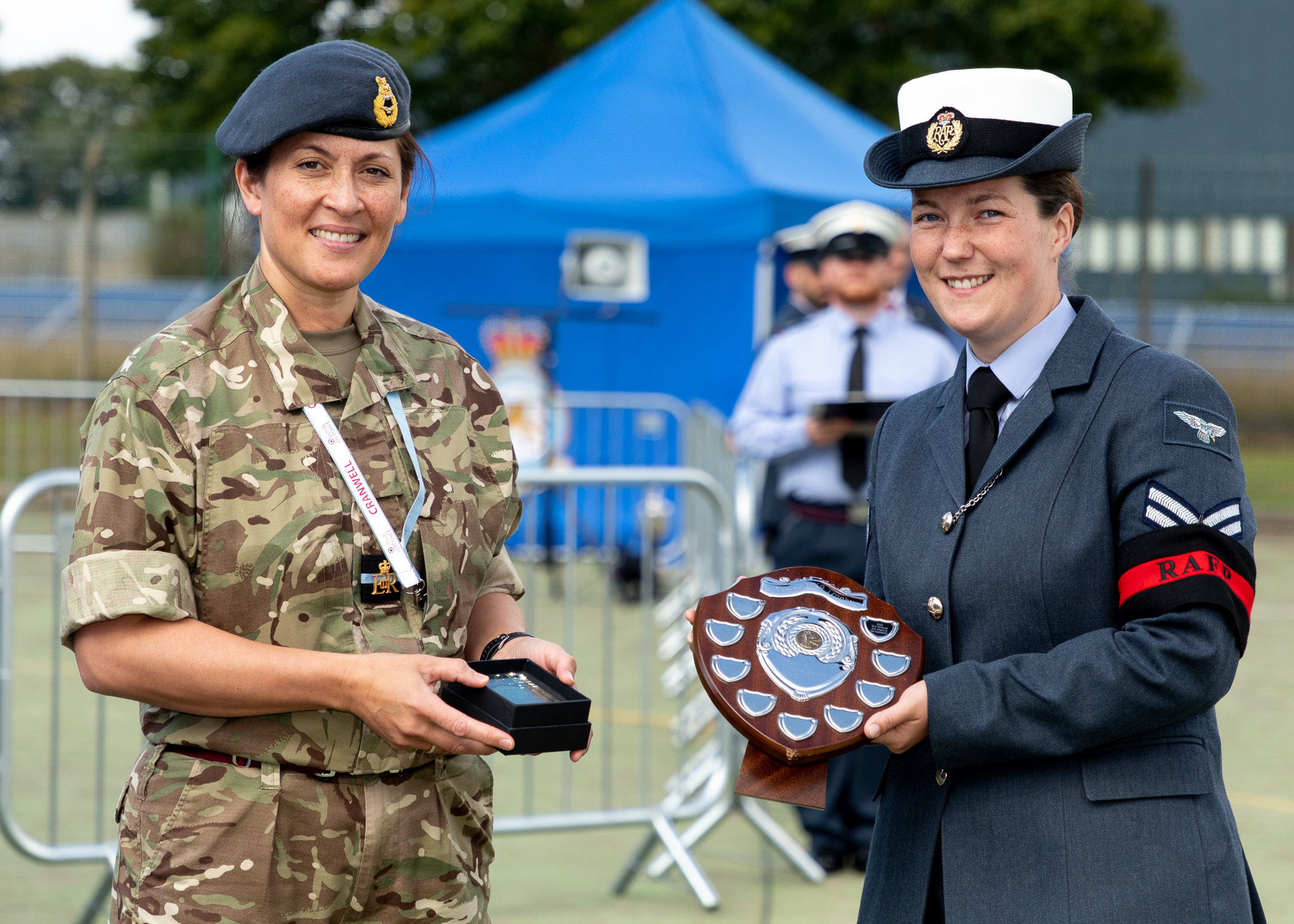 RAF Police Handler holds trophy.
