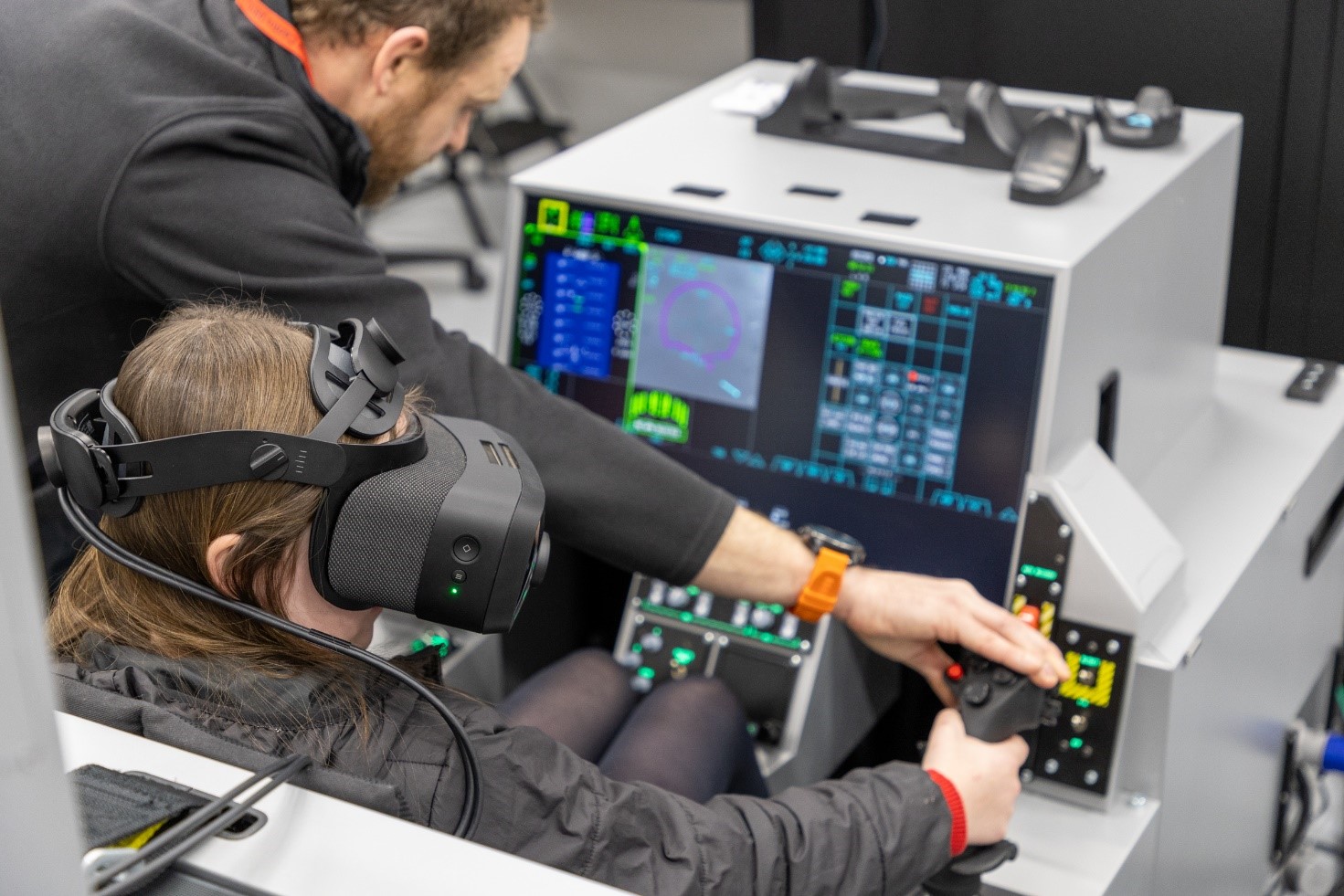 Image shows school child using virtual headset and joy stick on the virtual simulator.