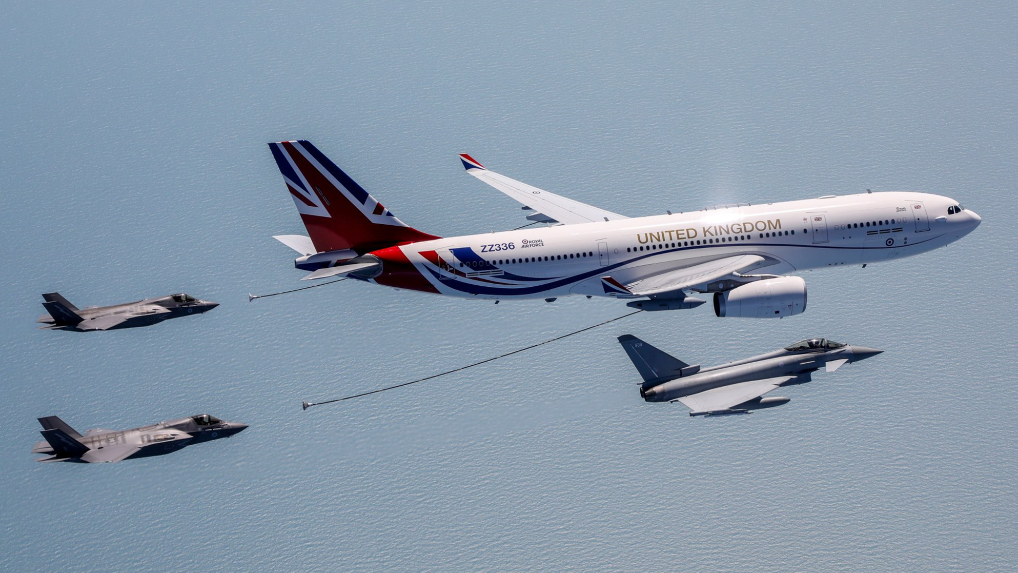 RAF Voyager refueling 2 F-35s flying alongside a RAF typhoon