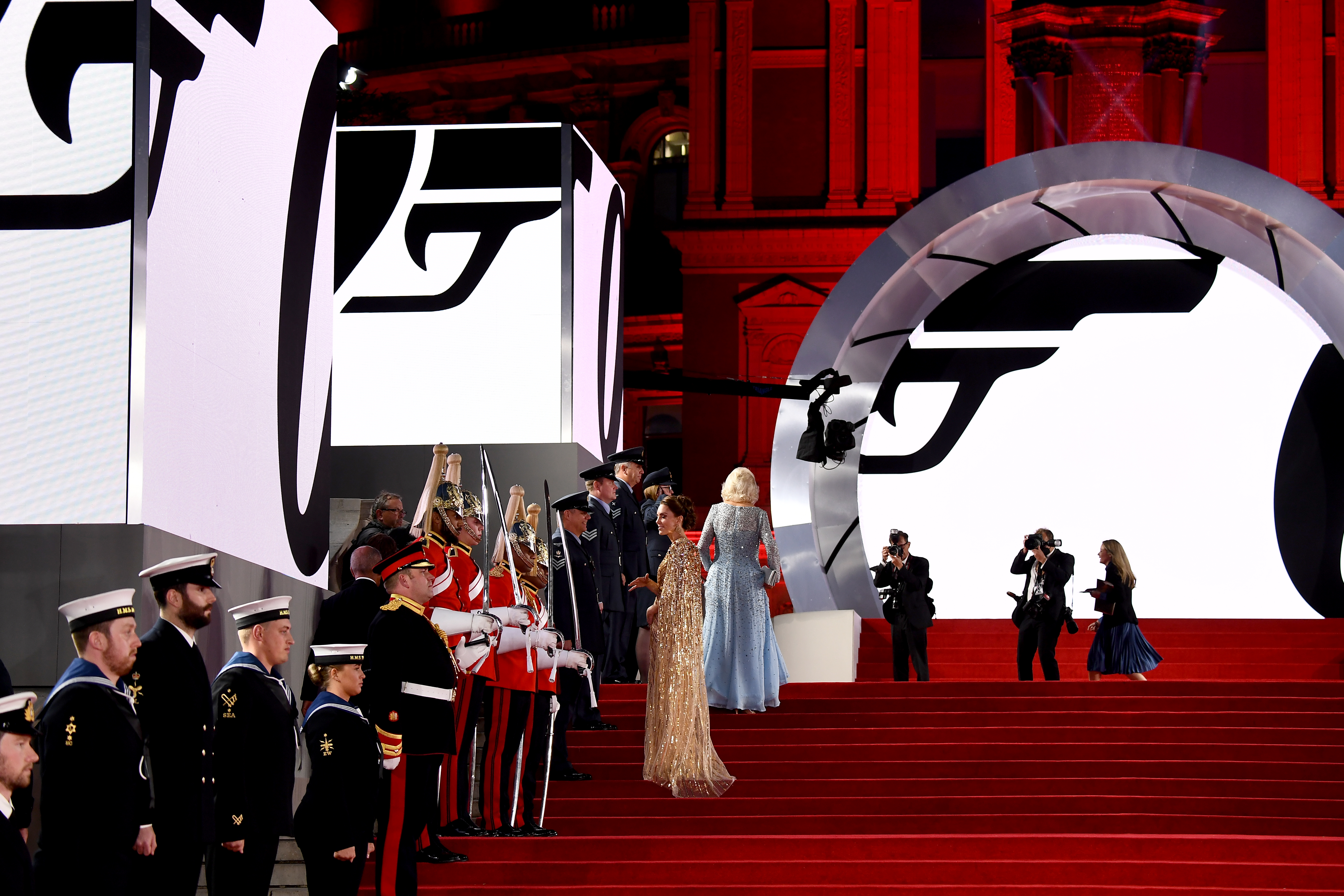 The Duchess of Cambridge on the red carpet, with Royal Navy and Household Cavalry personnel, and paparazzi.