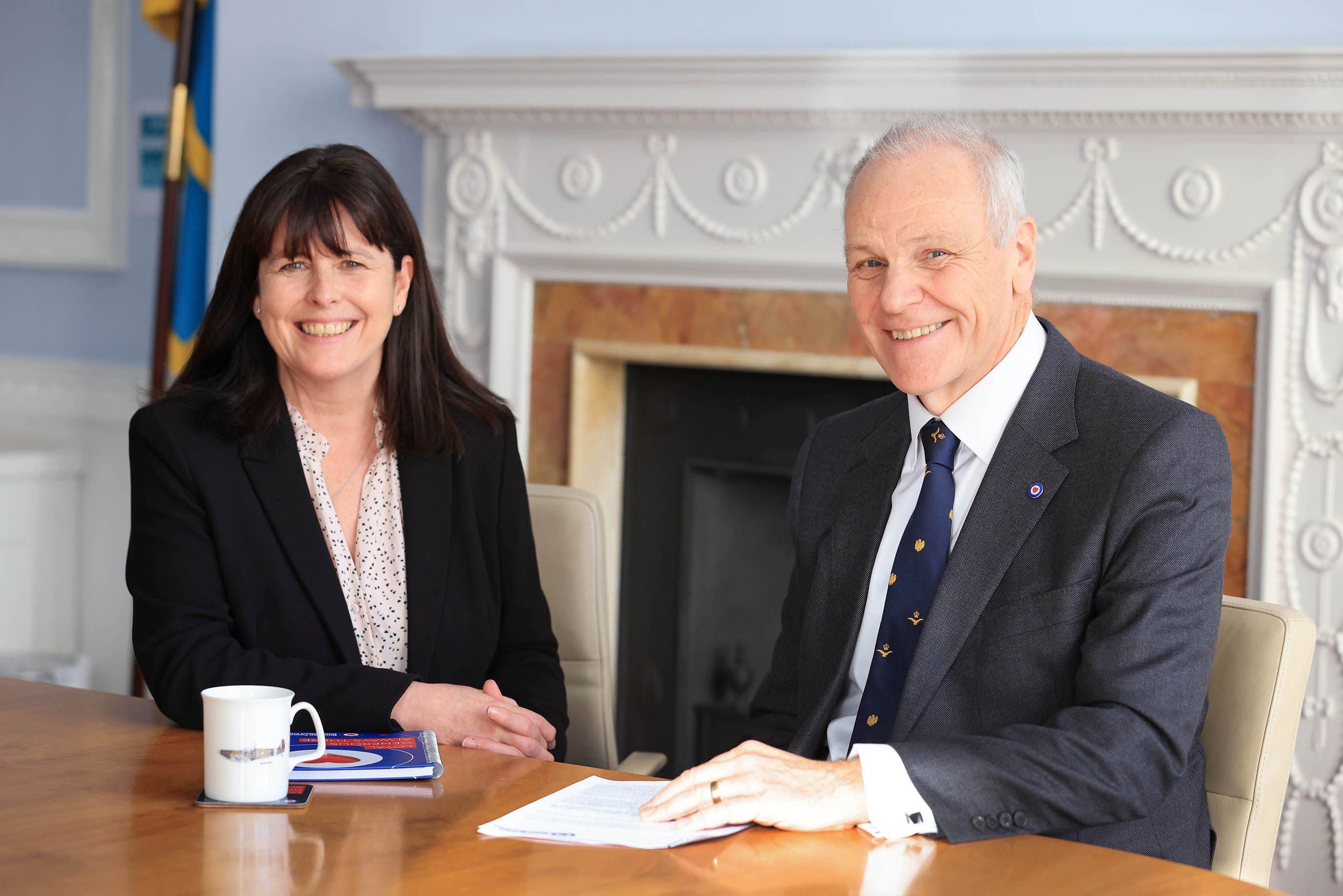 Air Vice-Marshal Elliot sits at table with Richard Daniel.