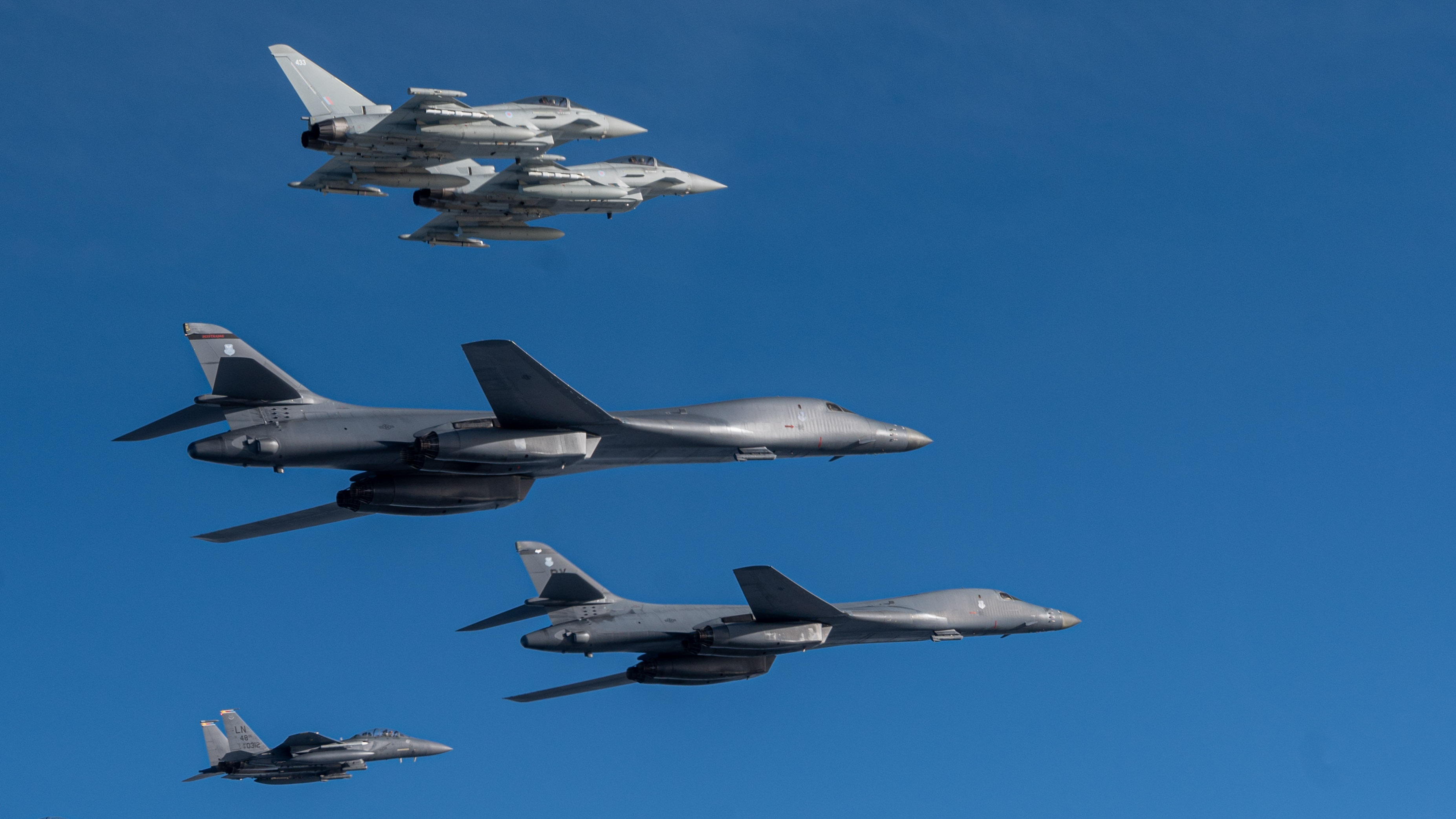 Aircraft fly in formation.