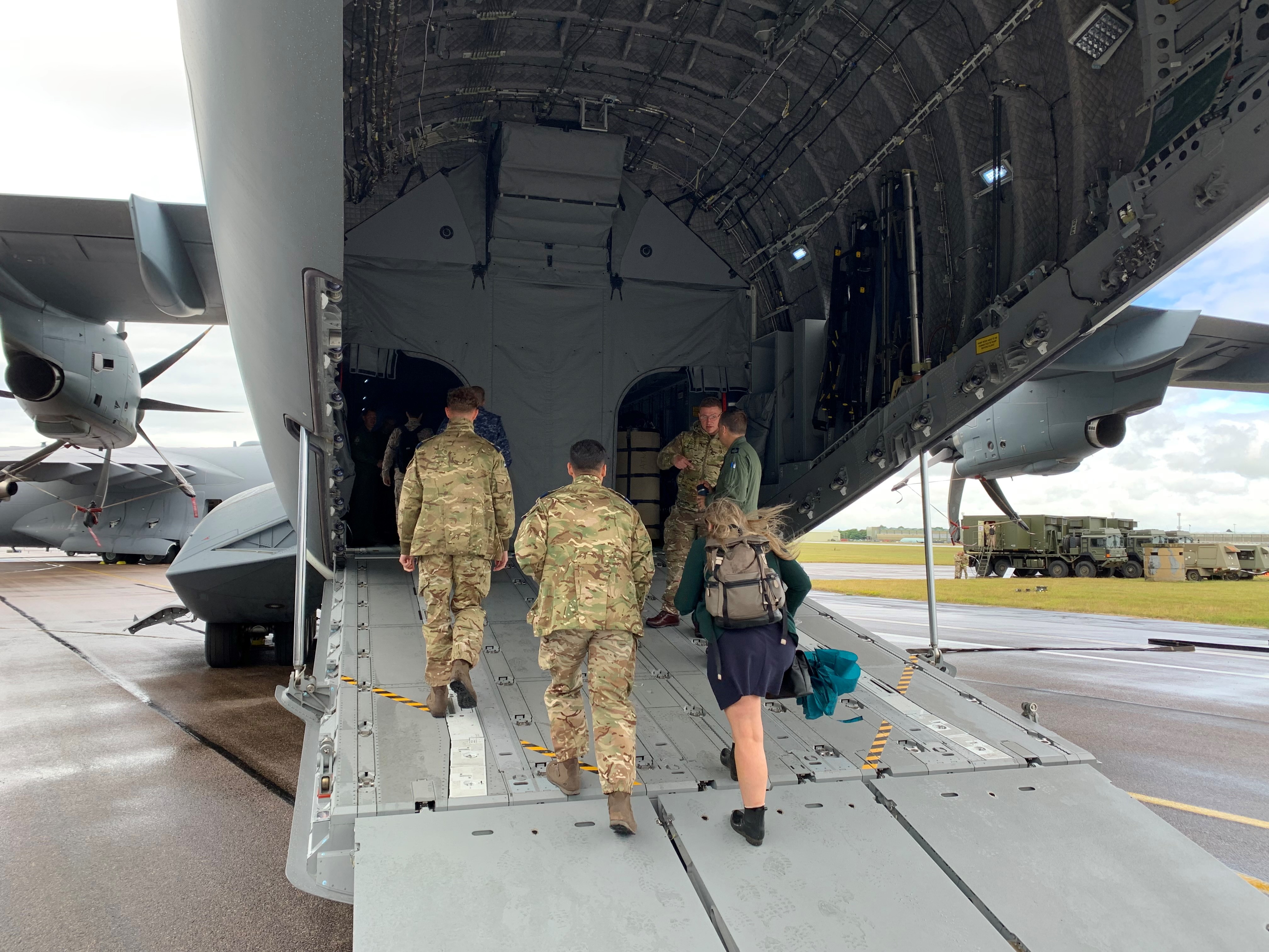 Cargo loading door of Poseidon open, with Aviators walking into the bay.