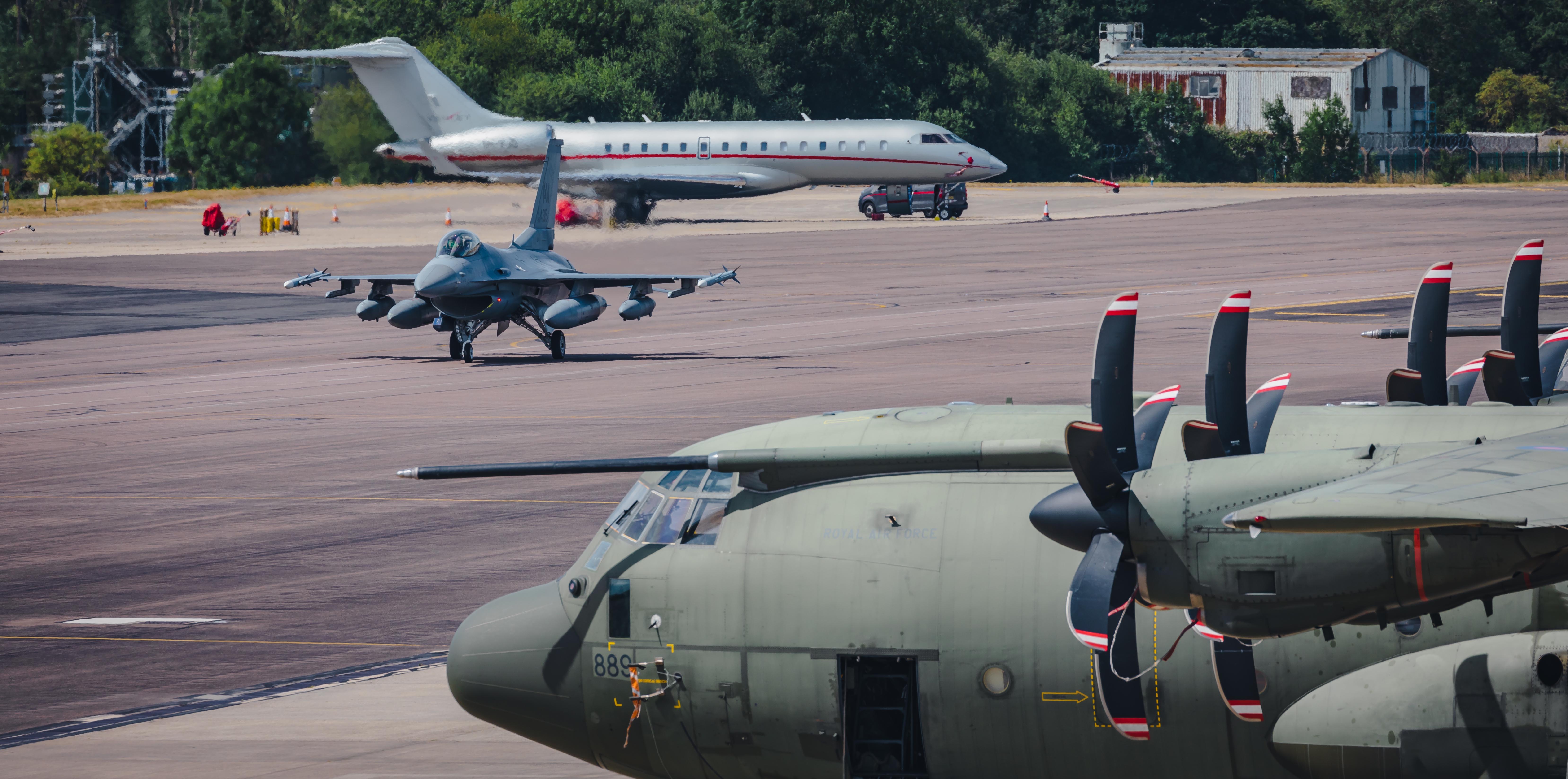 Image shows airfield with aircraft on the runway.