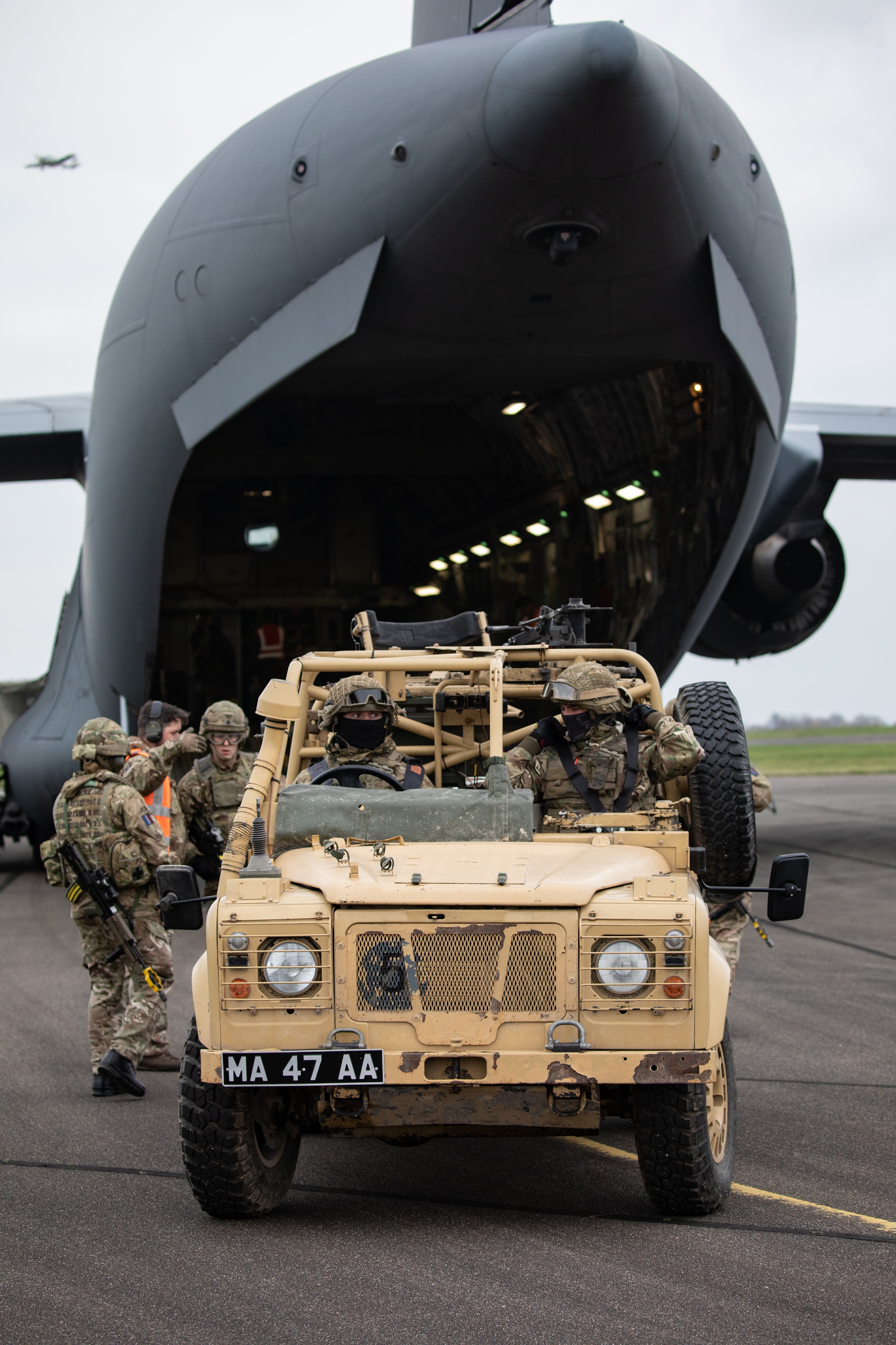 Personnel from No 1 Air Mobility Wing loading personnel and equipment from No 16 Air Assault Brigade onto a 99 Squadron RAF C-17