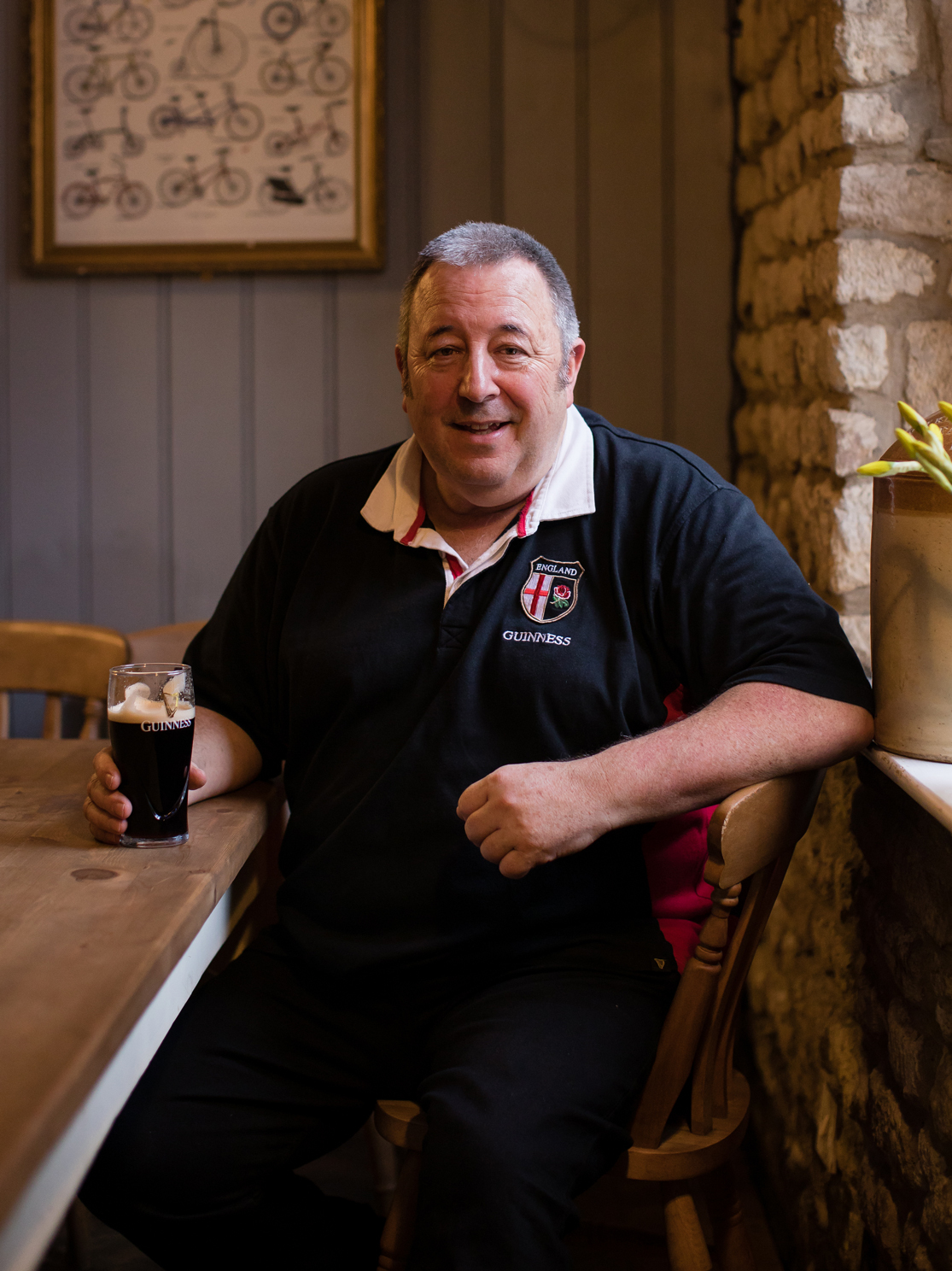 Personnel in pub with pint of Guinness.