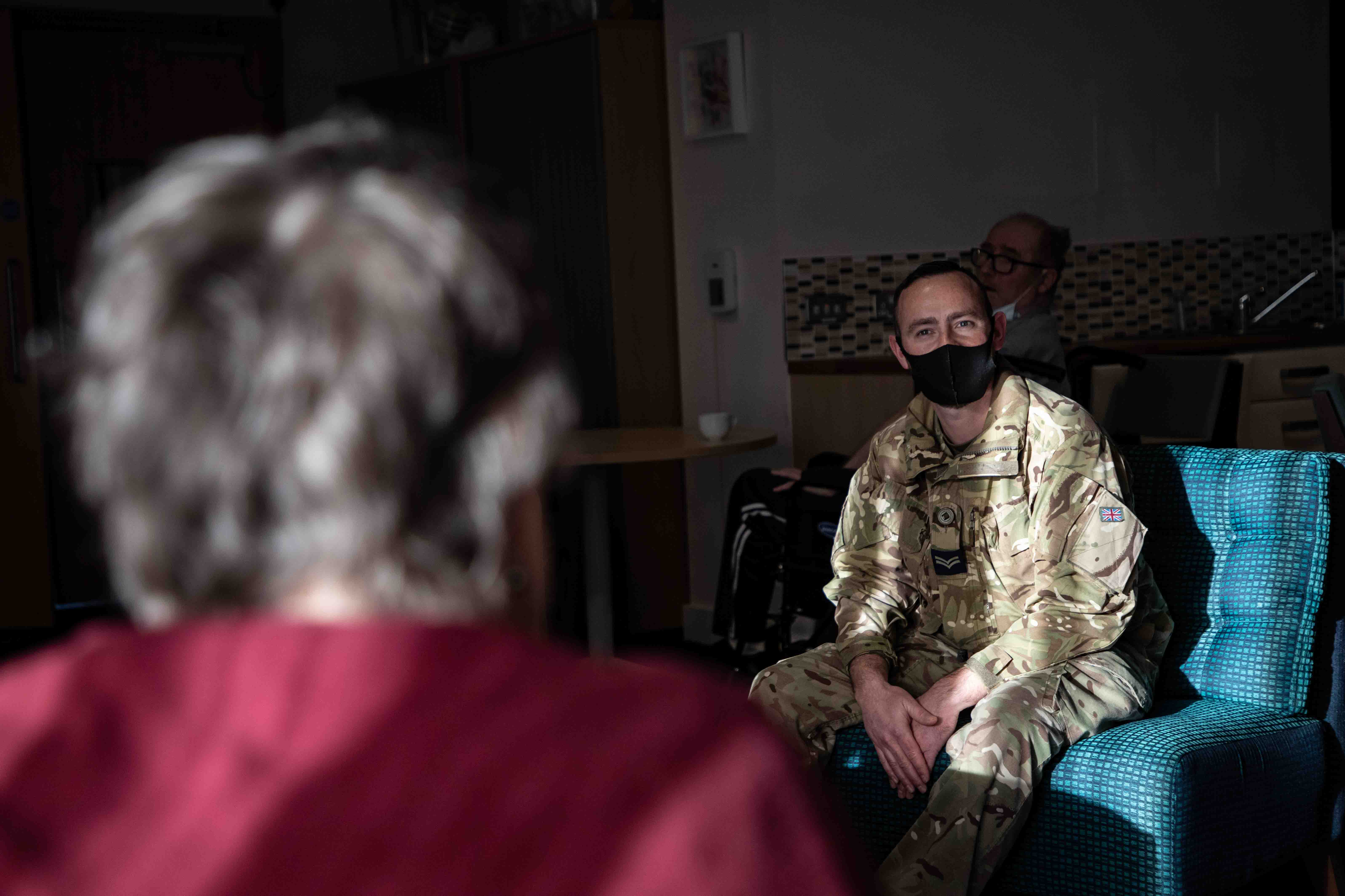 One of the residents in conversation with RAF Chef, Corporal James McInerney