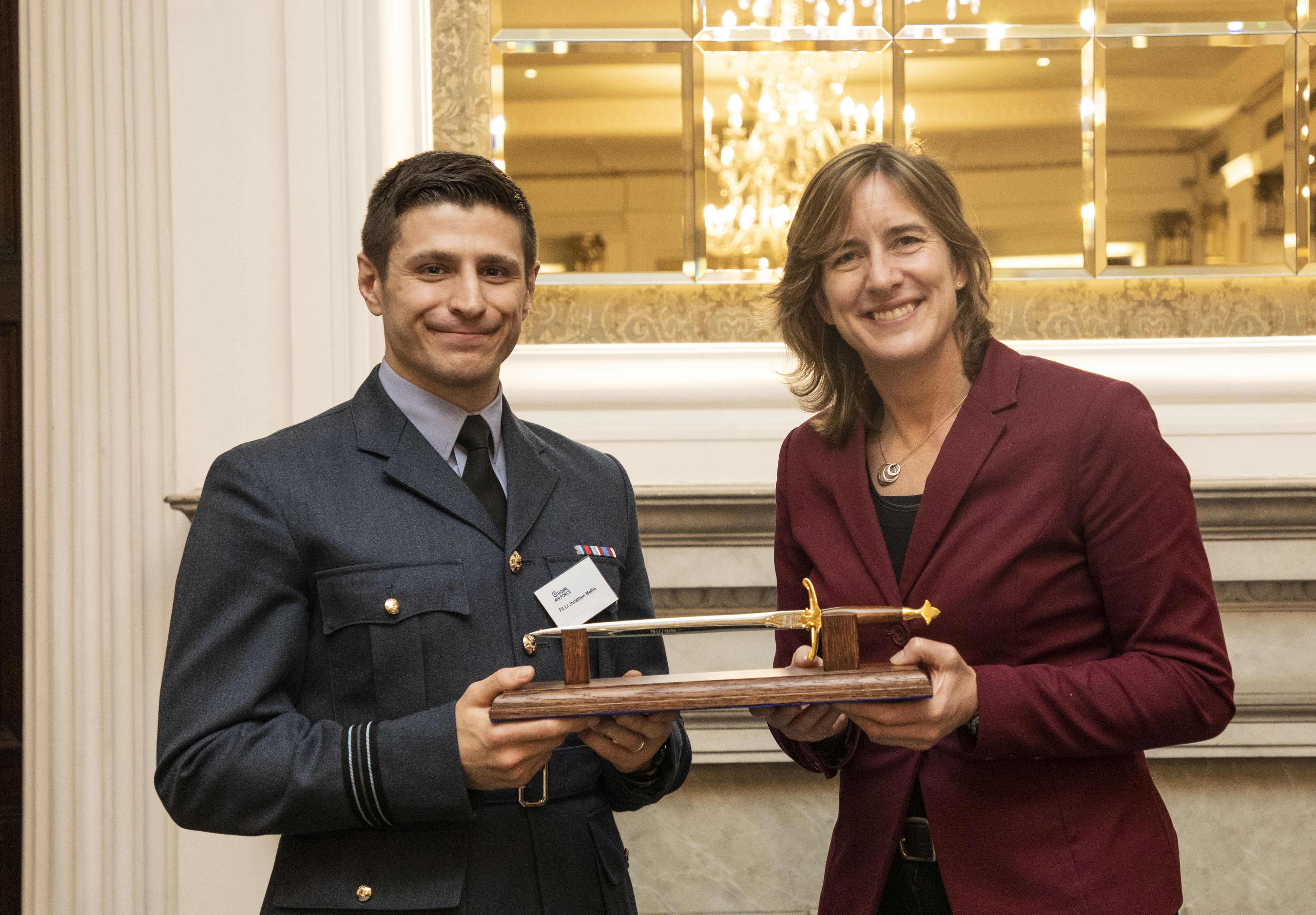 Caroline presents Jonathon with his award.