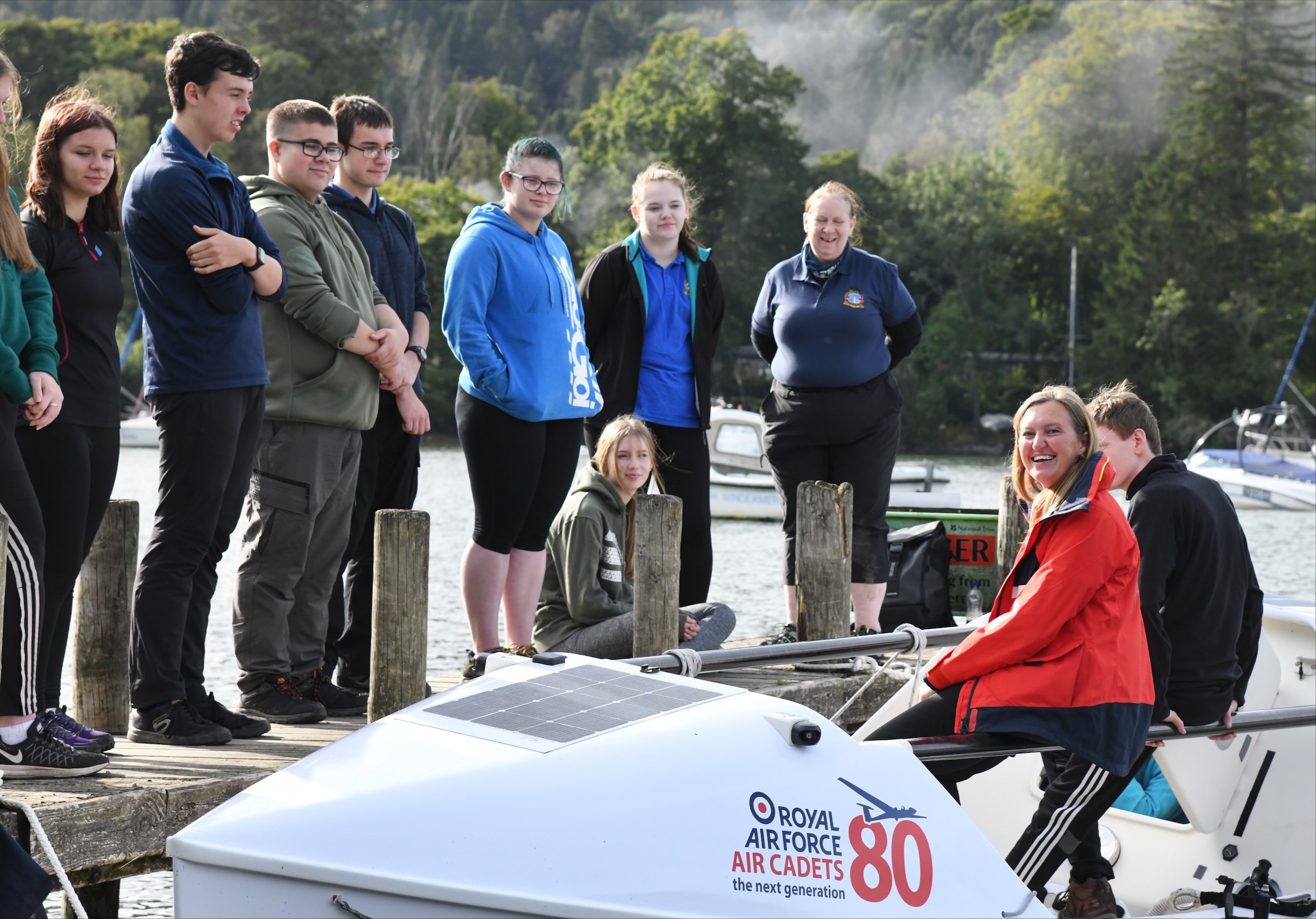 Cadets gather around a boat.