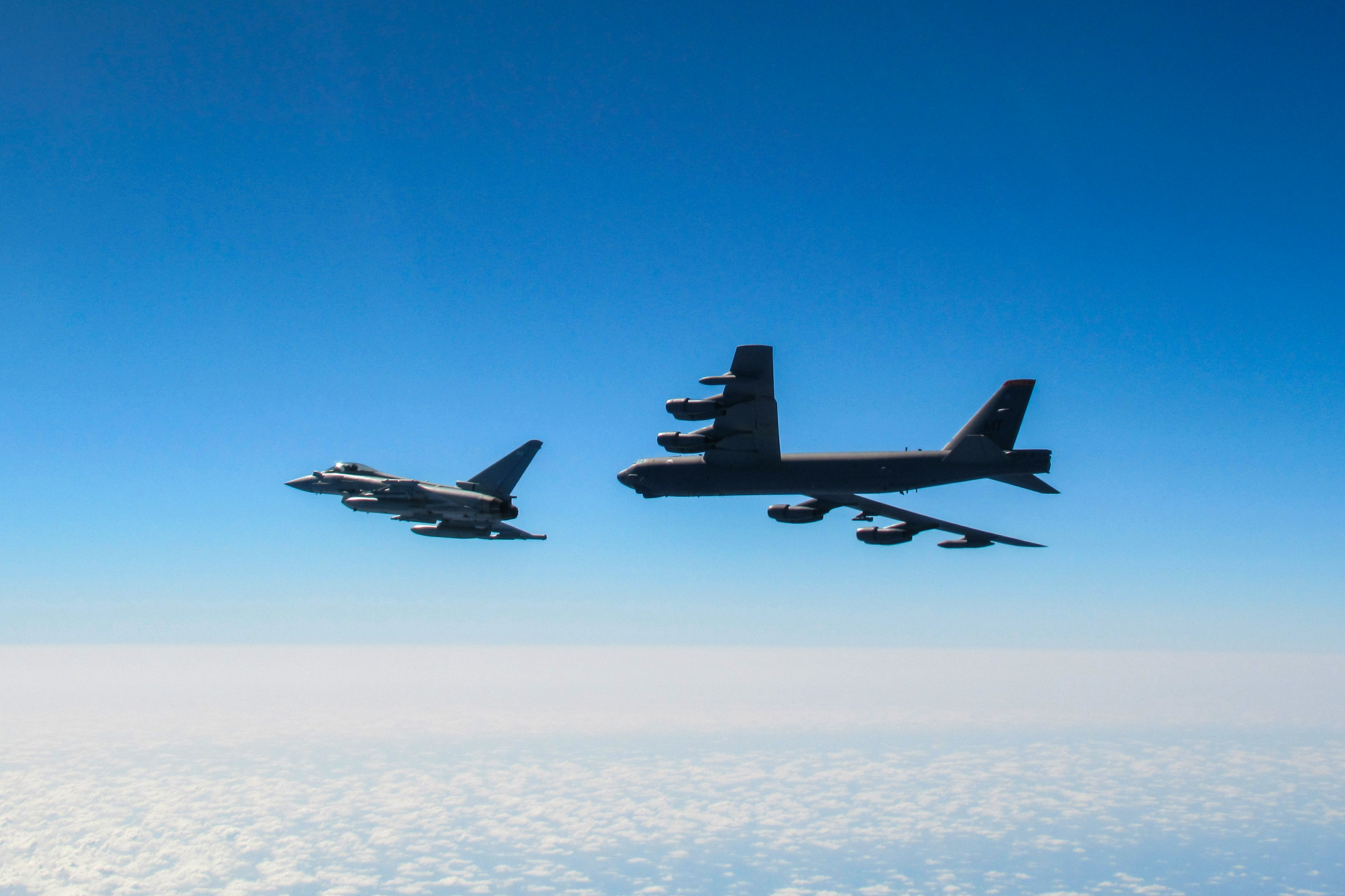 Image shows a RAF Typhoon and B-52 Stratofortresses.