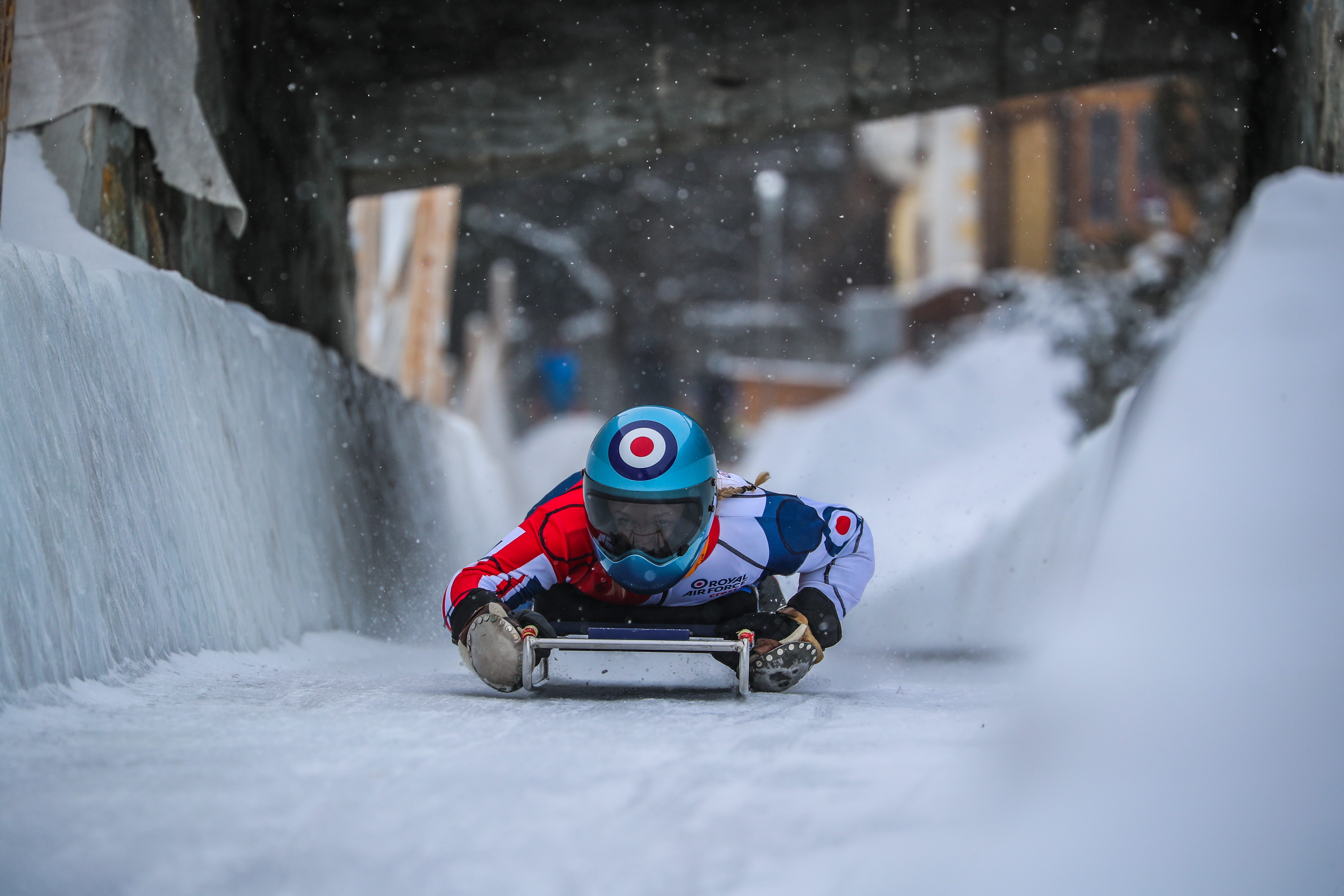 Image shows RAF aviator using a skeleton on the snow course.
