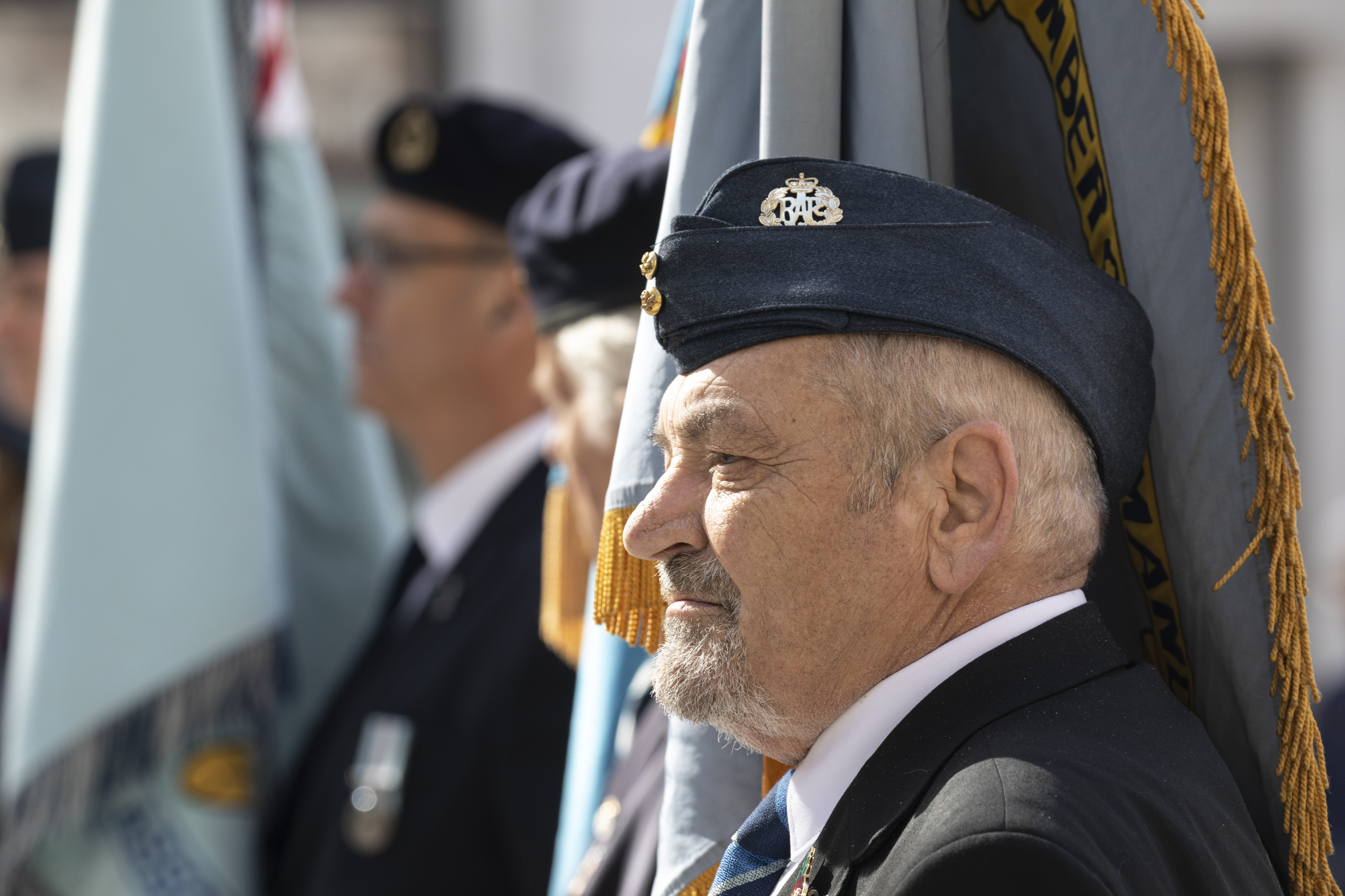 Personnel hold flags during the parade.