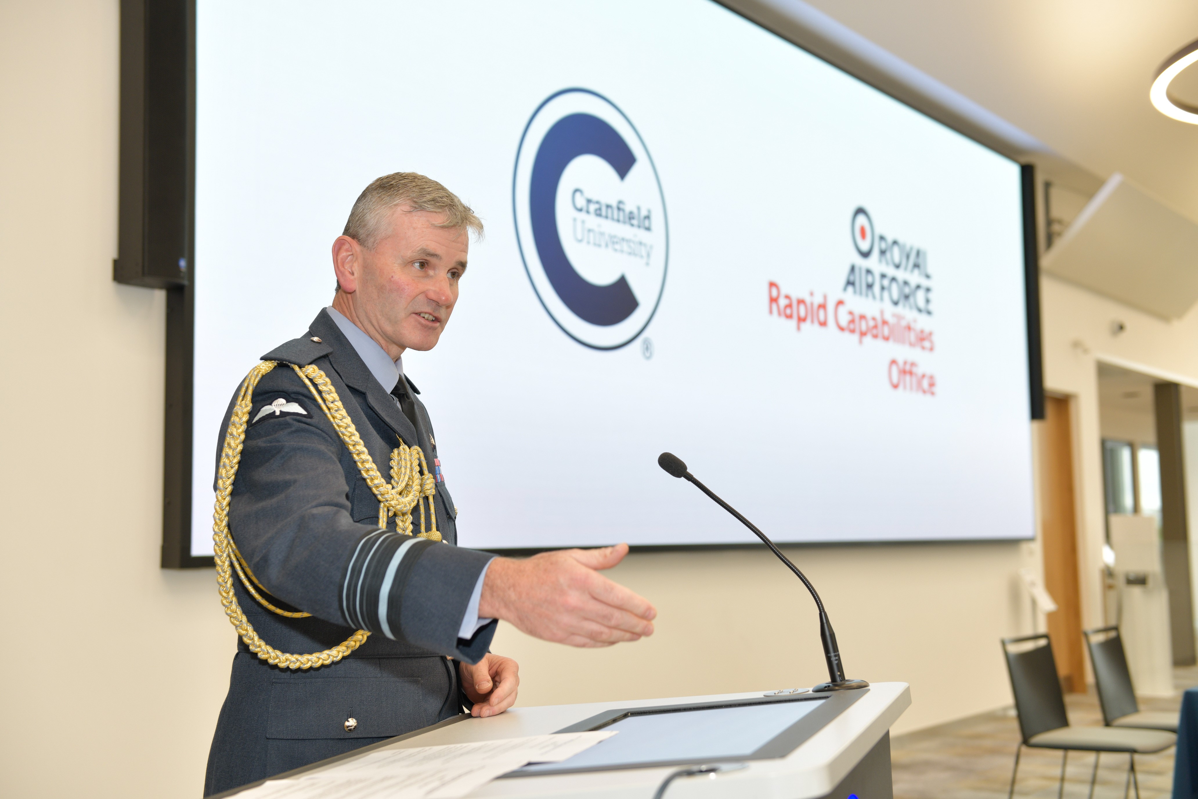 Air Marshal Turner at a presentation stand giving talk. 