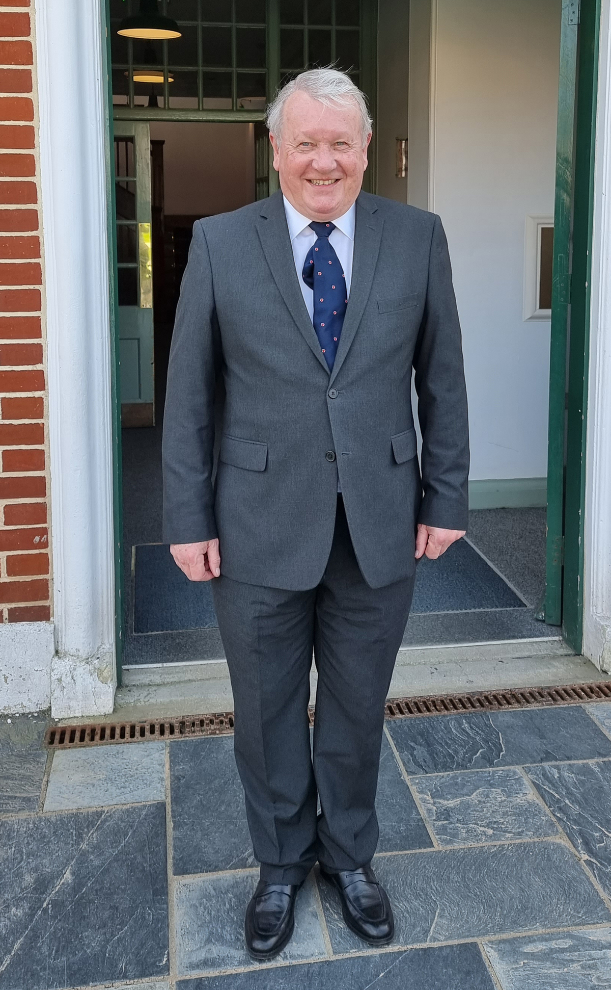 Mike stands outside building.