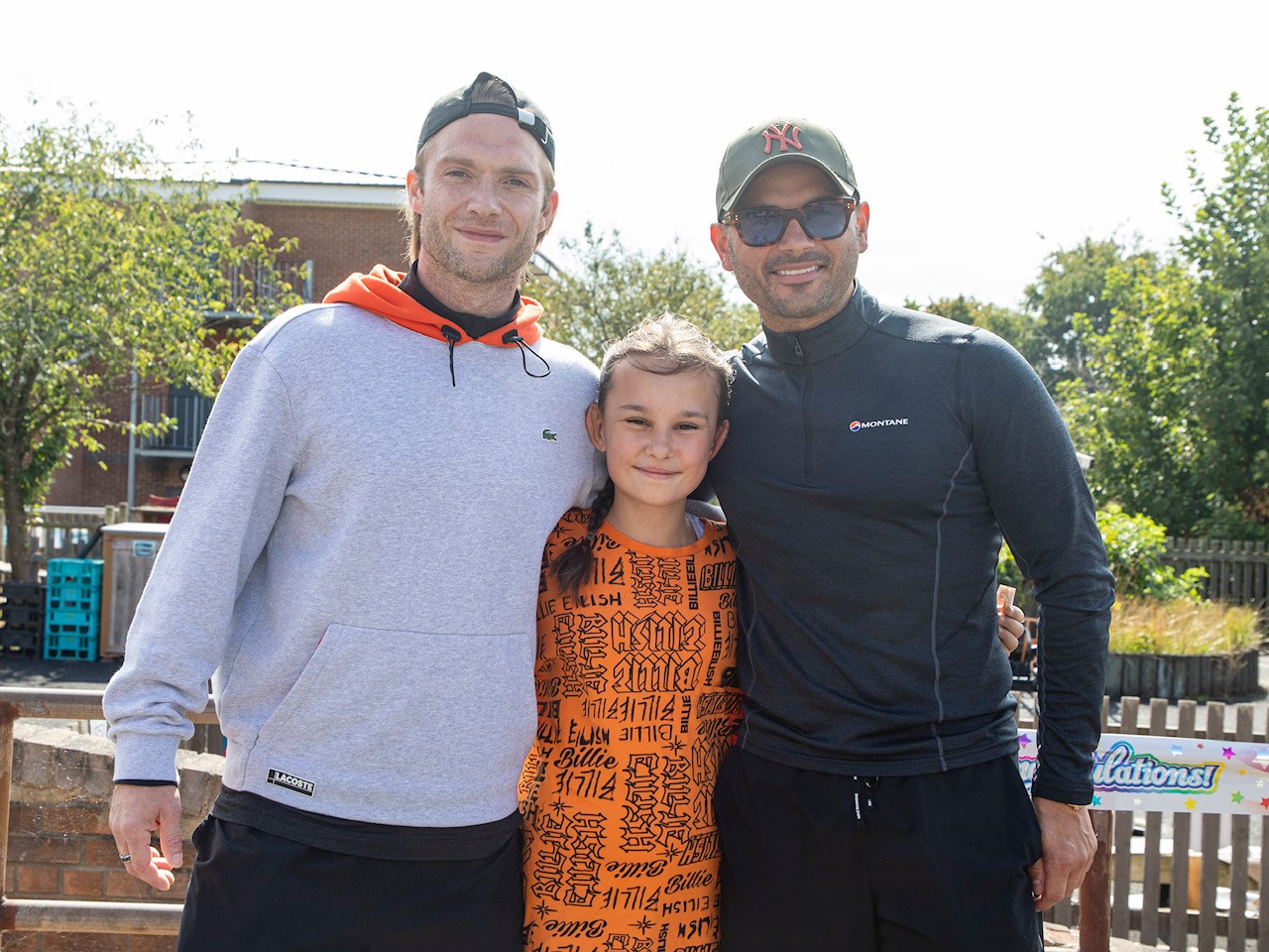 Katie poses with Ryan and Chris, with huge smiles all round