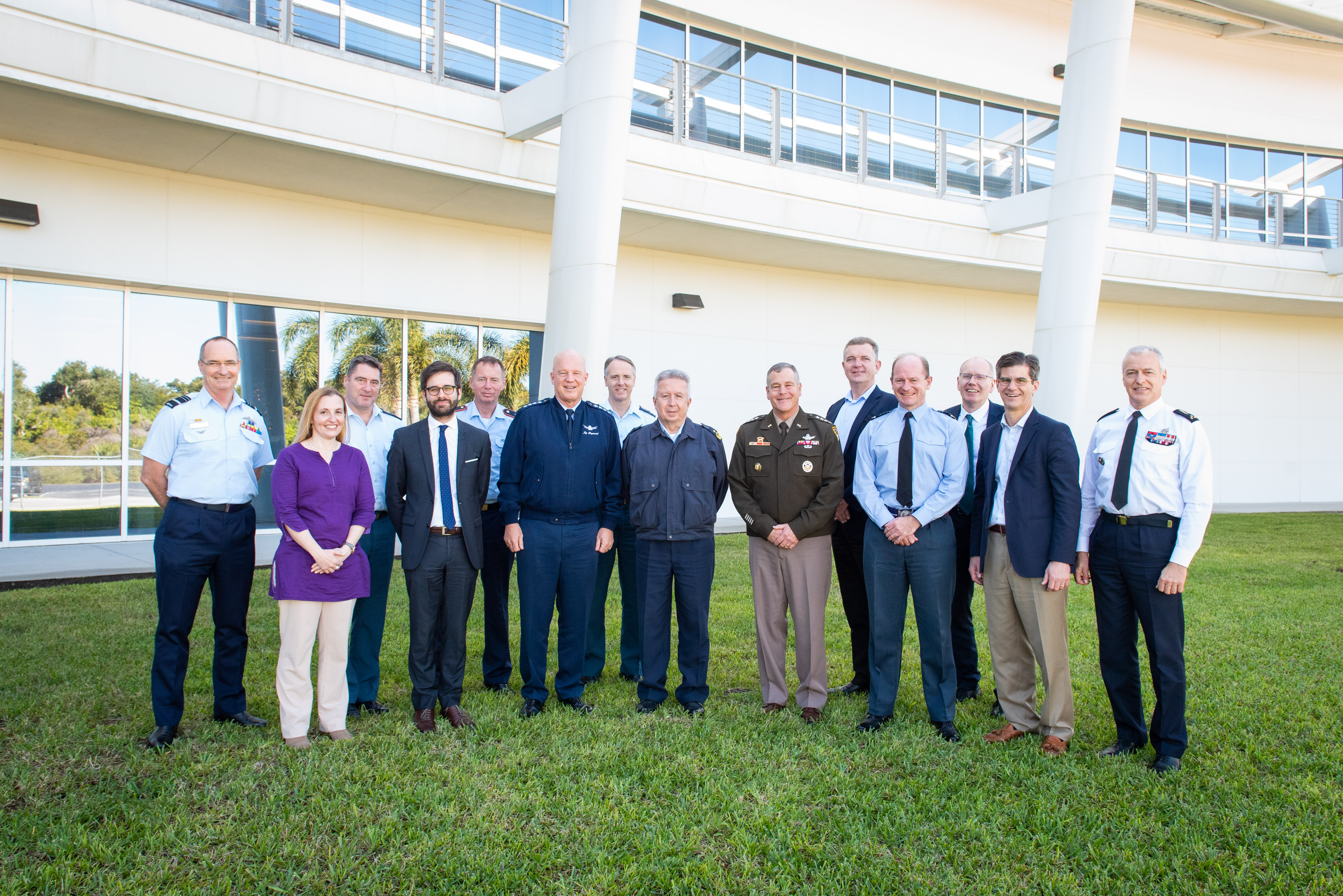 Personnel group standing outside building.