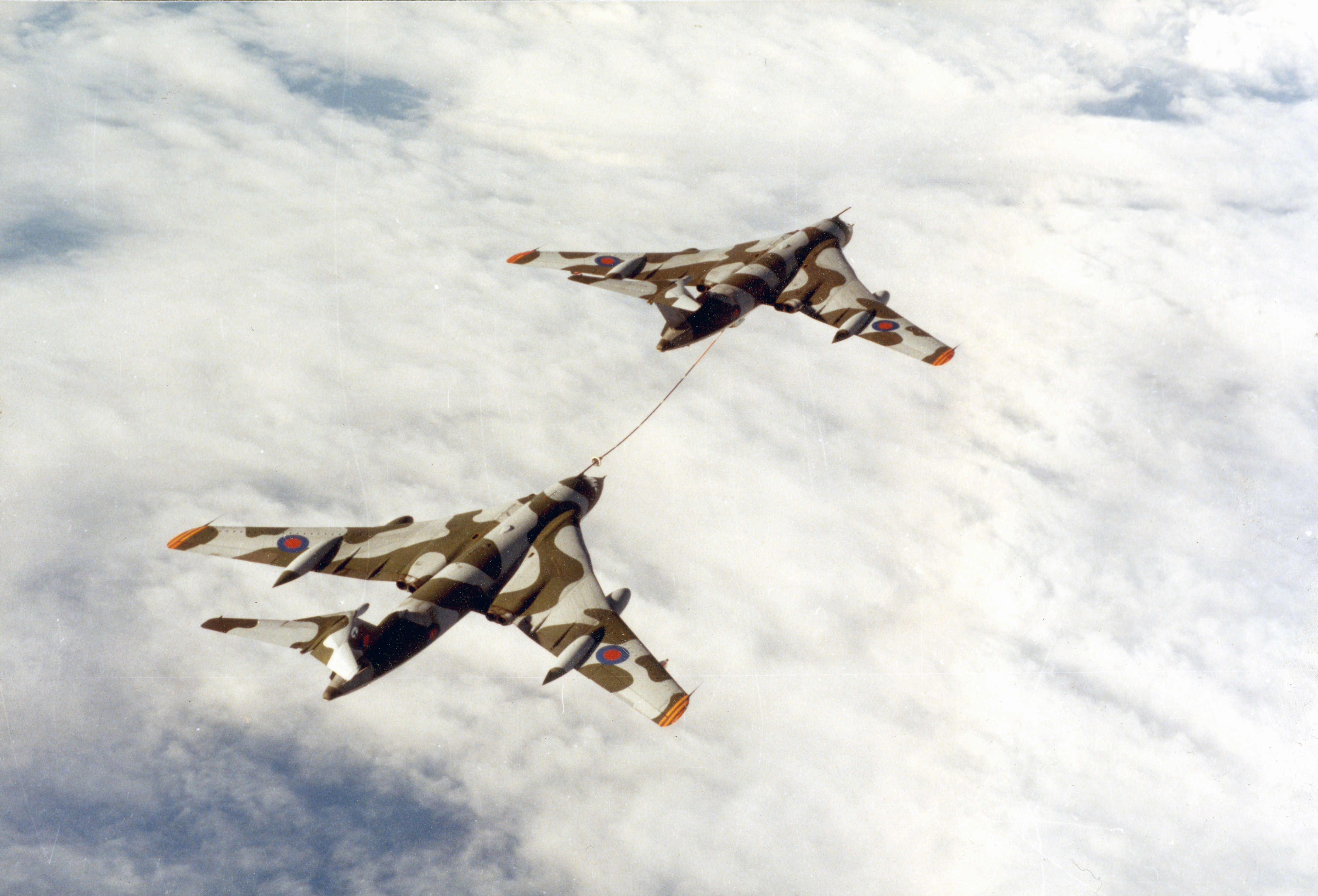 Victor tanker aircraft conduct air-to-air refuelling.