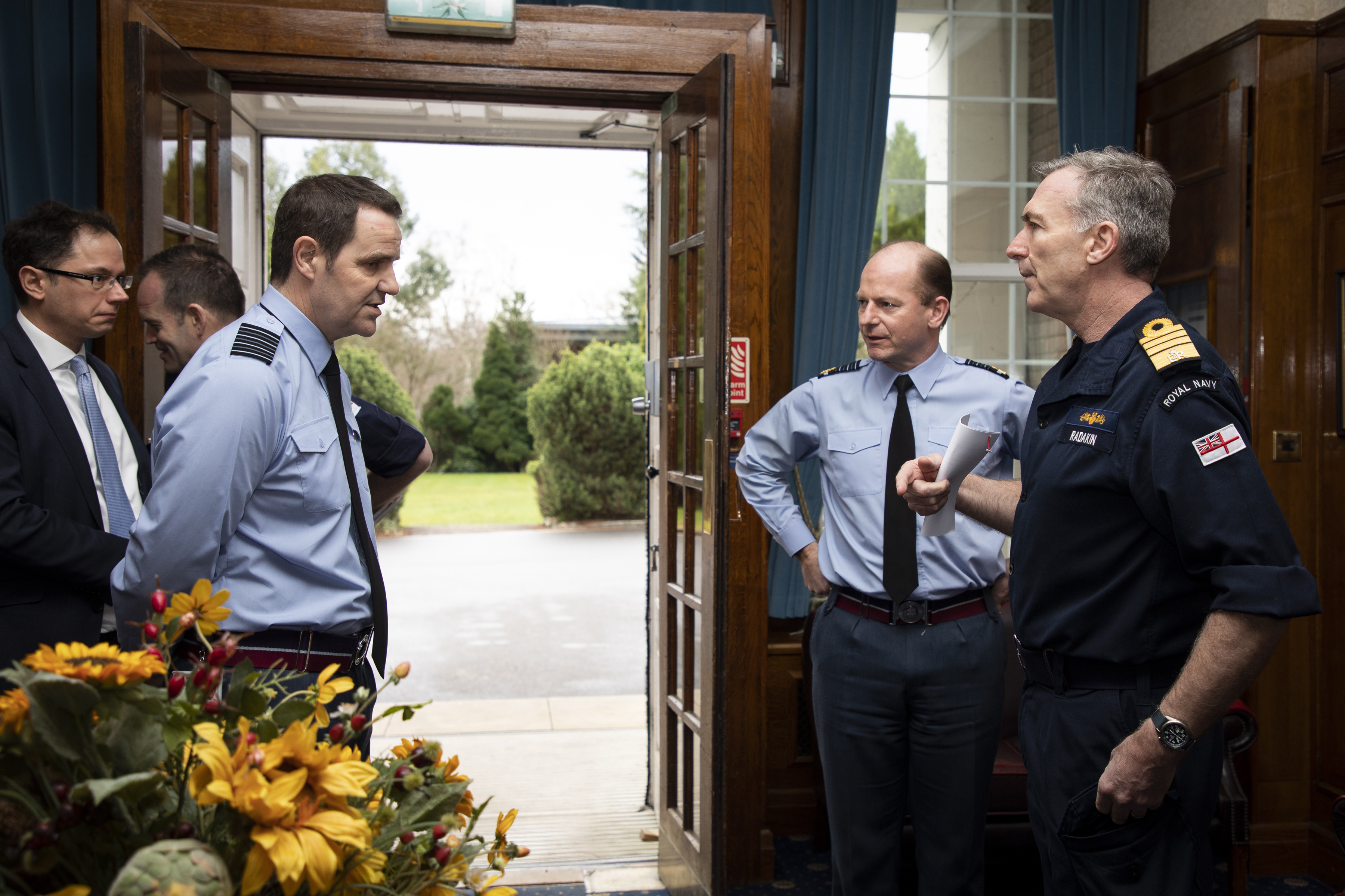 Personnel stand in foyer.