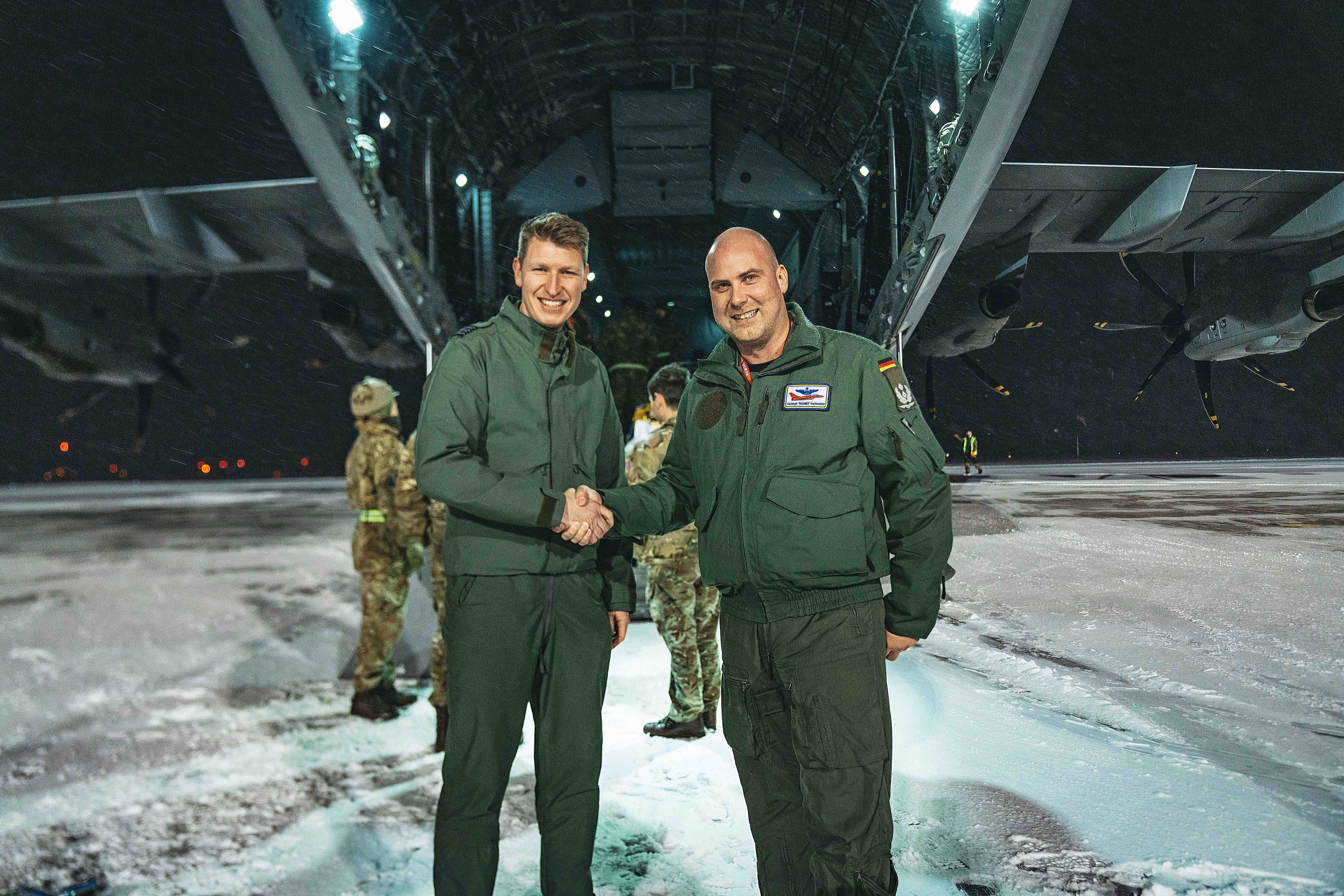 Image shows RAF aviator and German Air Force personnel shaking hands.