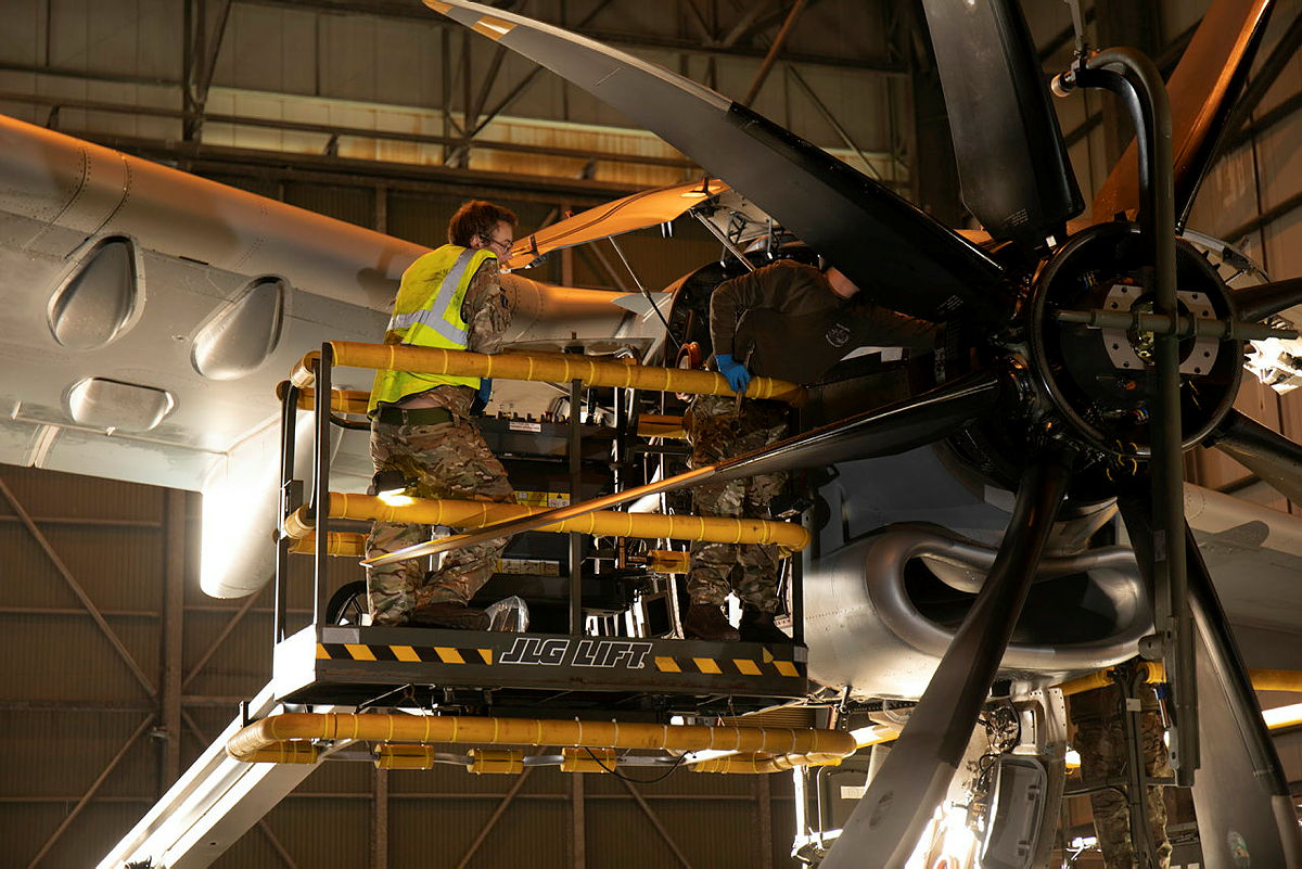 Engineers work on an aircraft in the hangar.