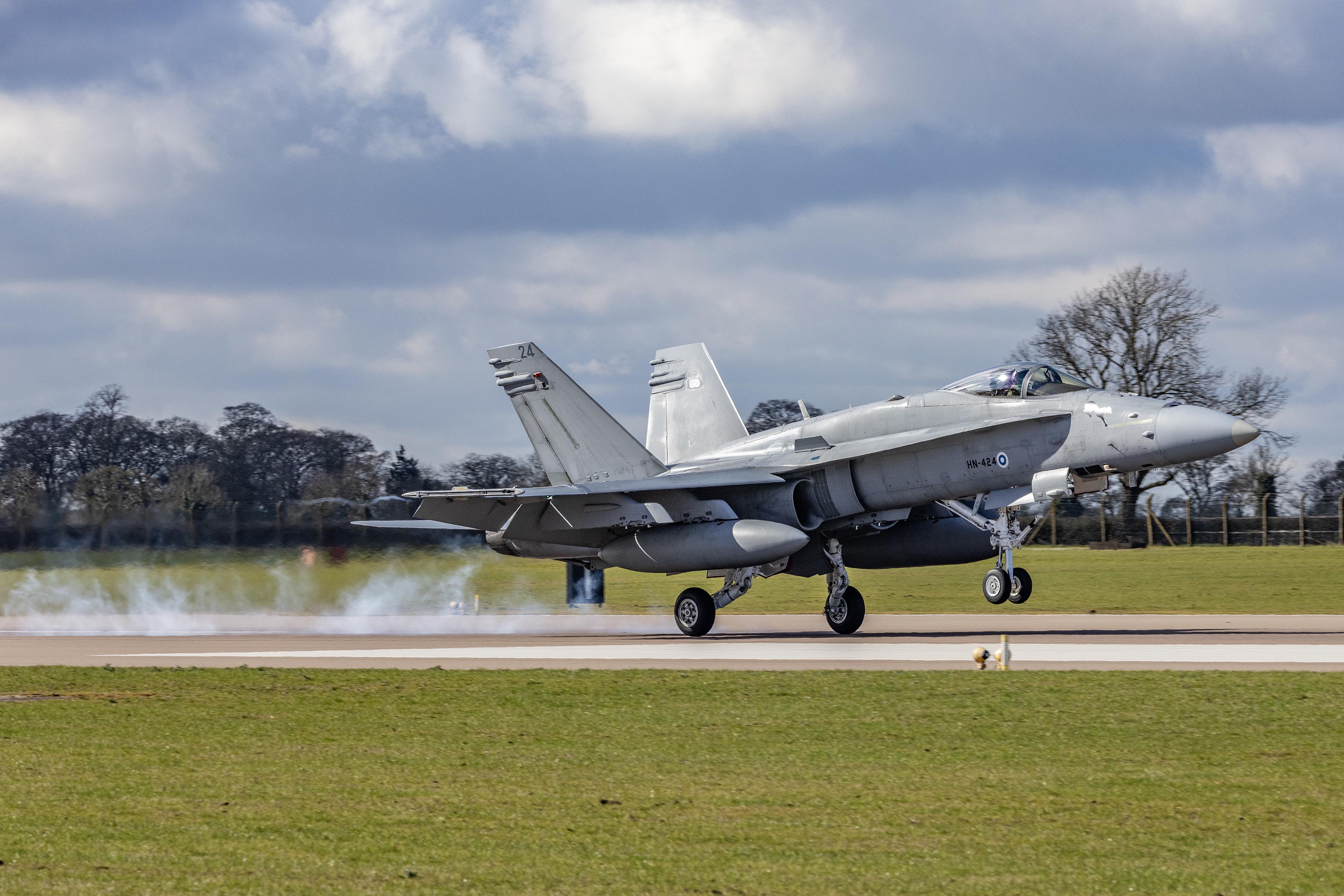 Image shows fighter aircraft taking off from the airfield.