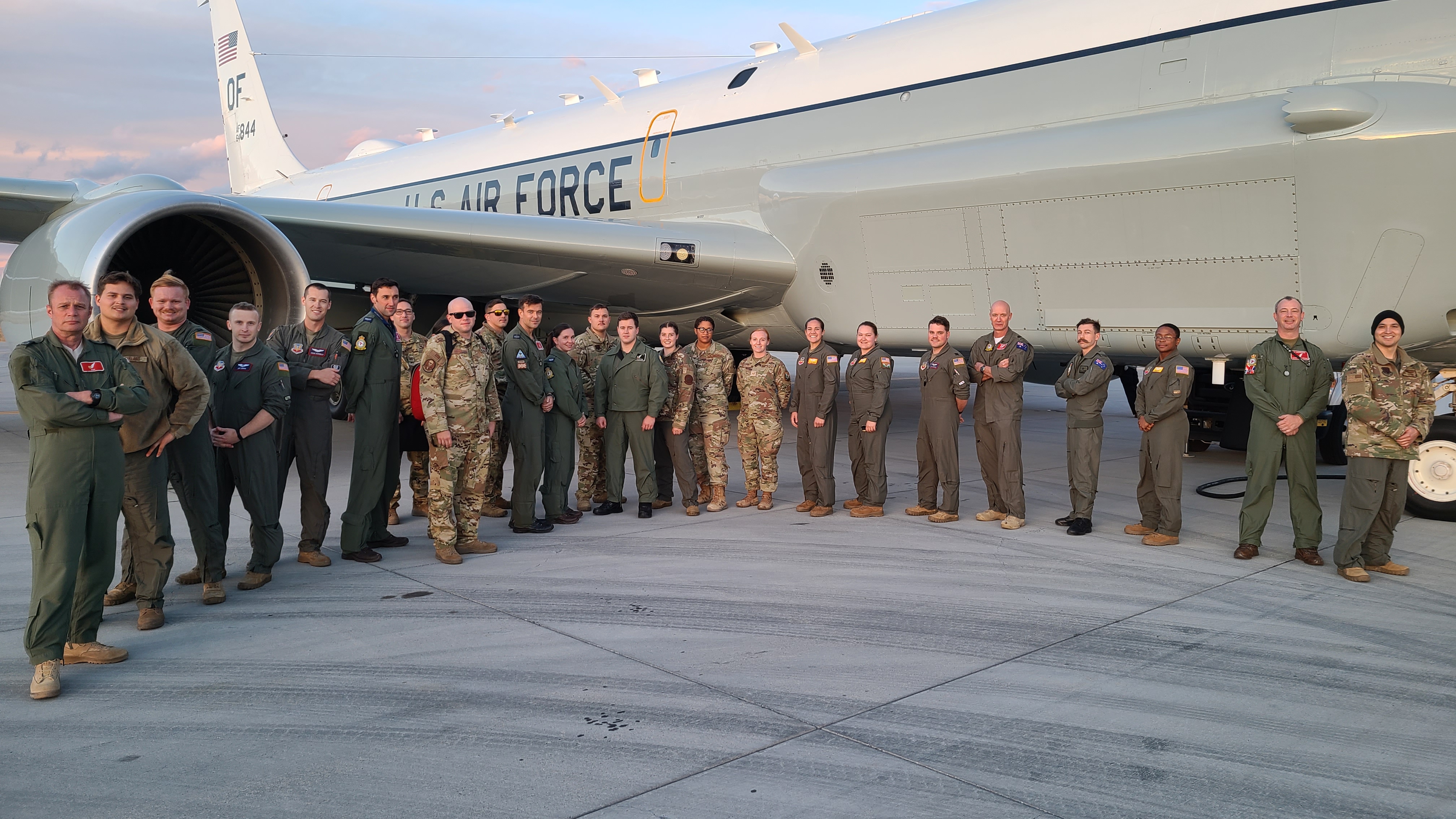 Images shows military personnel stood in front of a Rivet Joint aircraft.