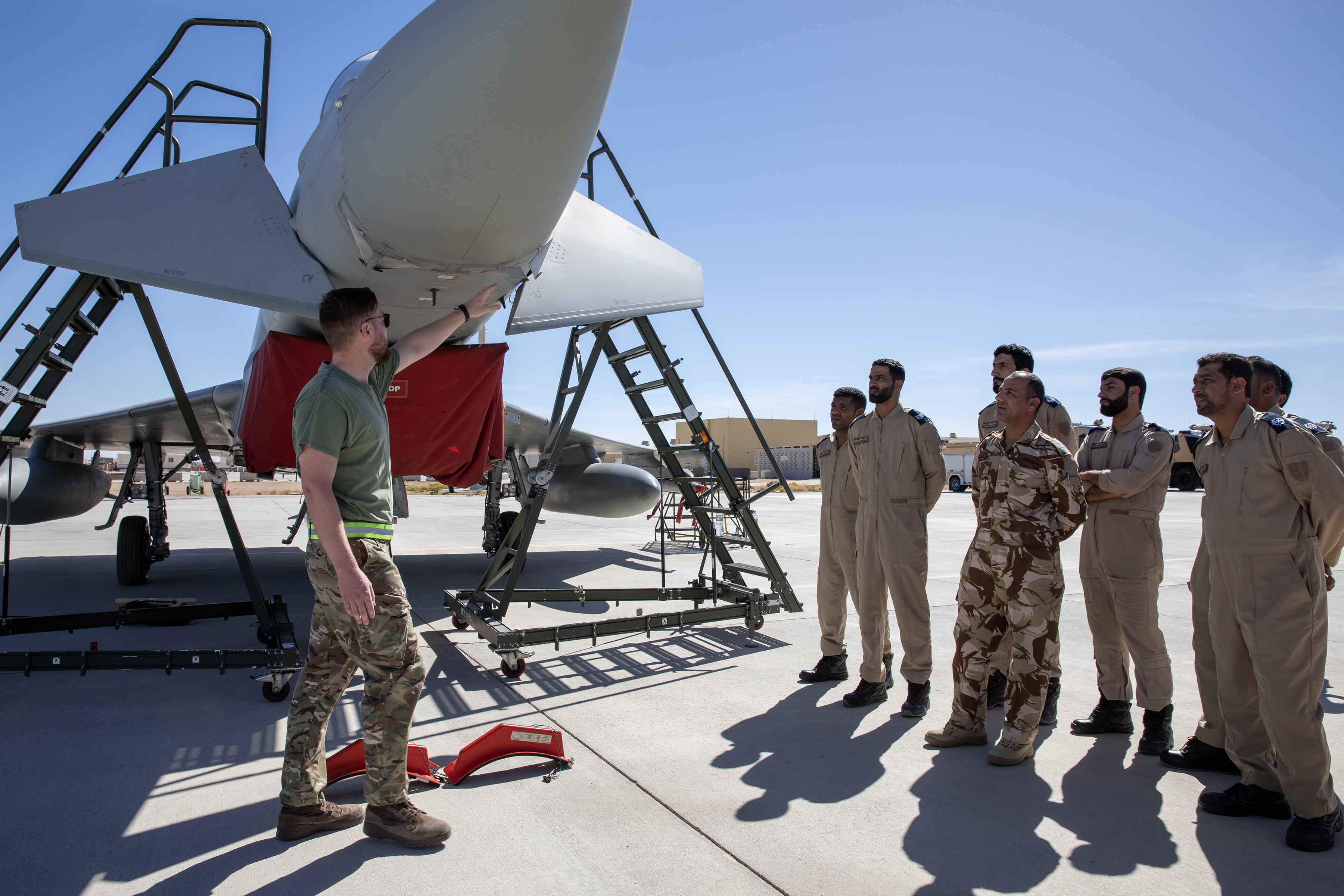 Image shows personnel standing with a RAF Typhoon on the airfield.
