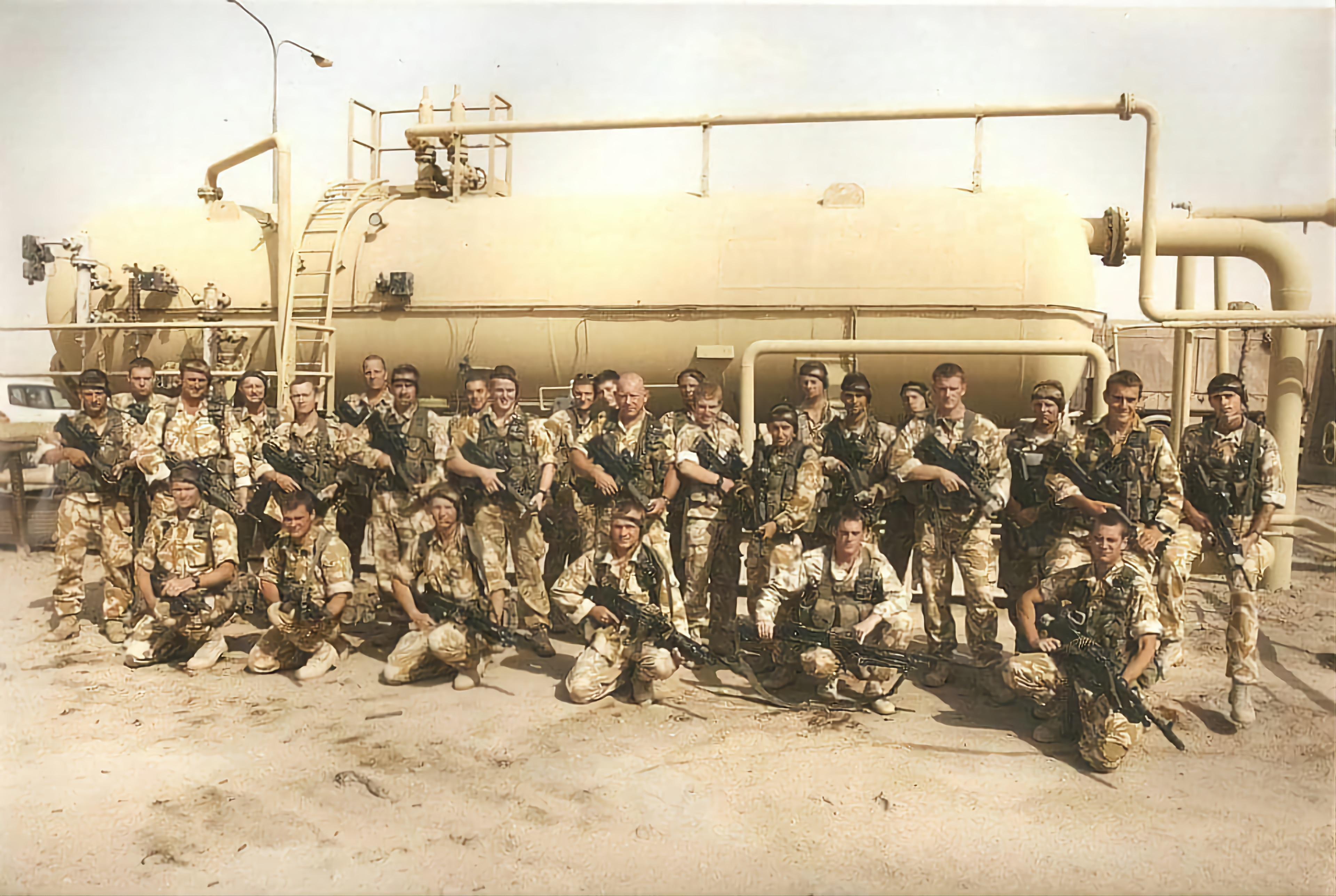 Image shows RAF personnel with rifles and wearing camouflage in Iraq. 