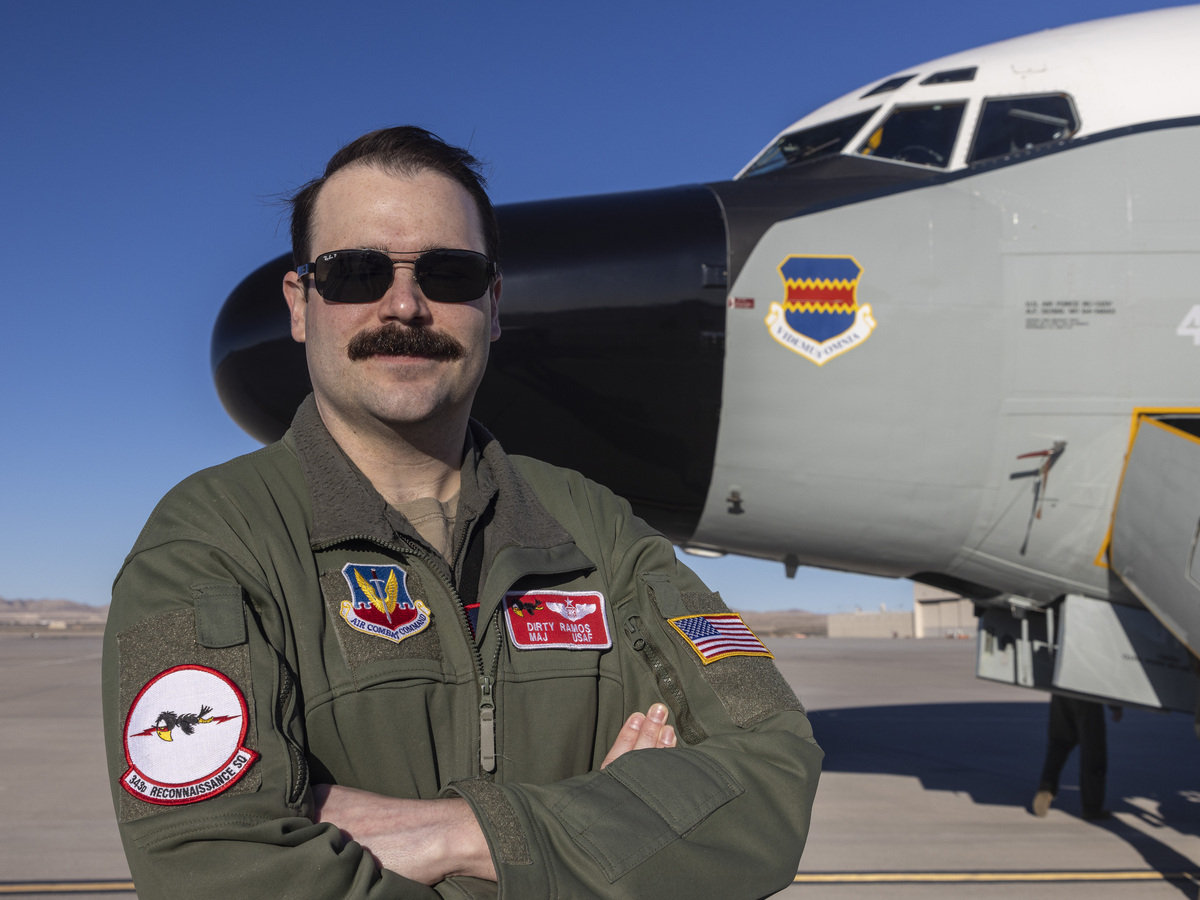 Image shows aviator standing with a Rivet Joint aircraft.