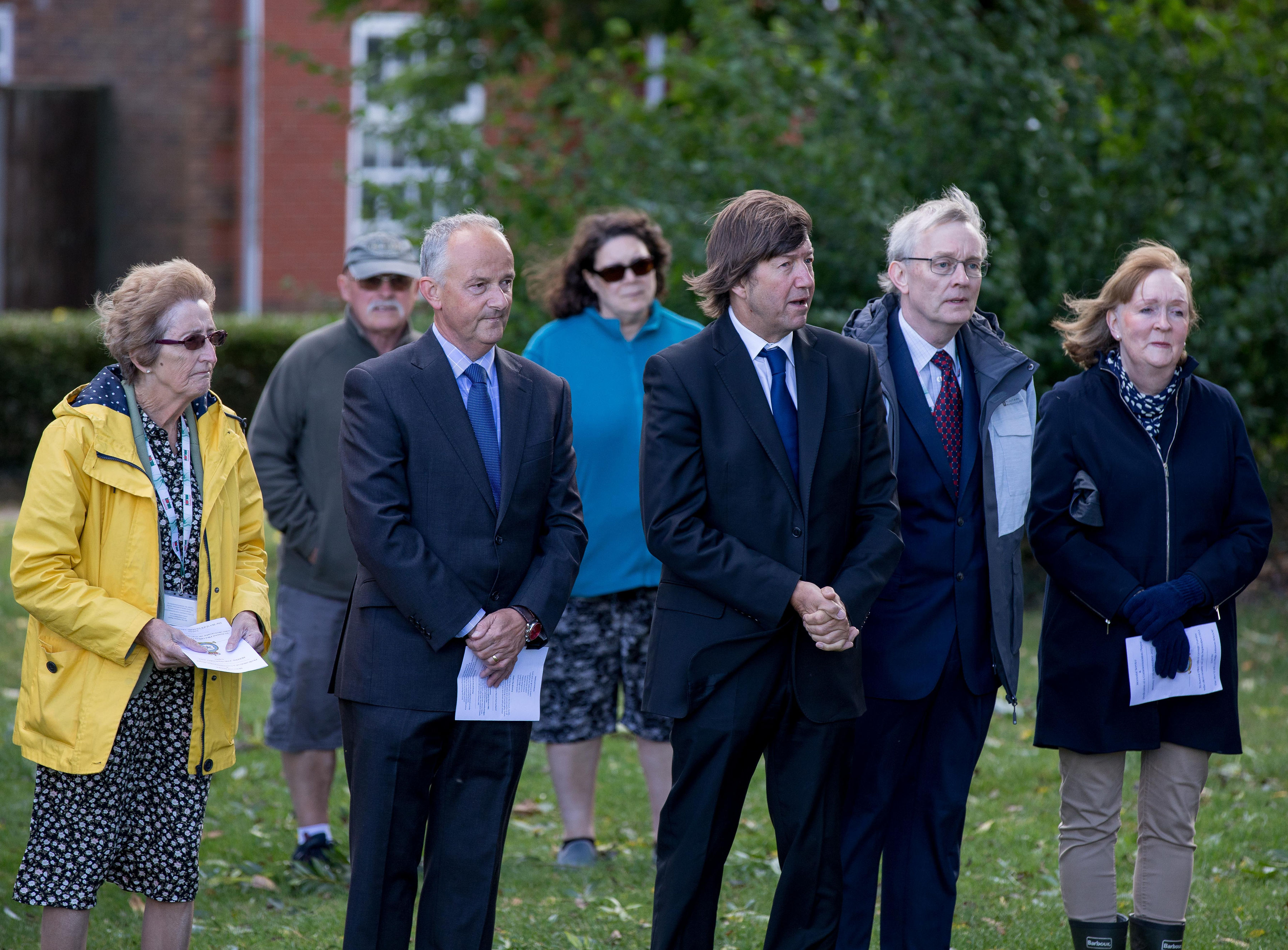 Members of the public stand at service.