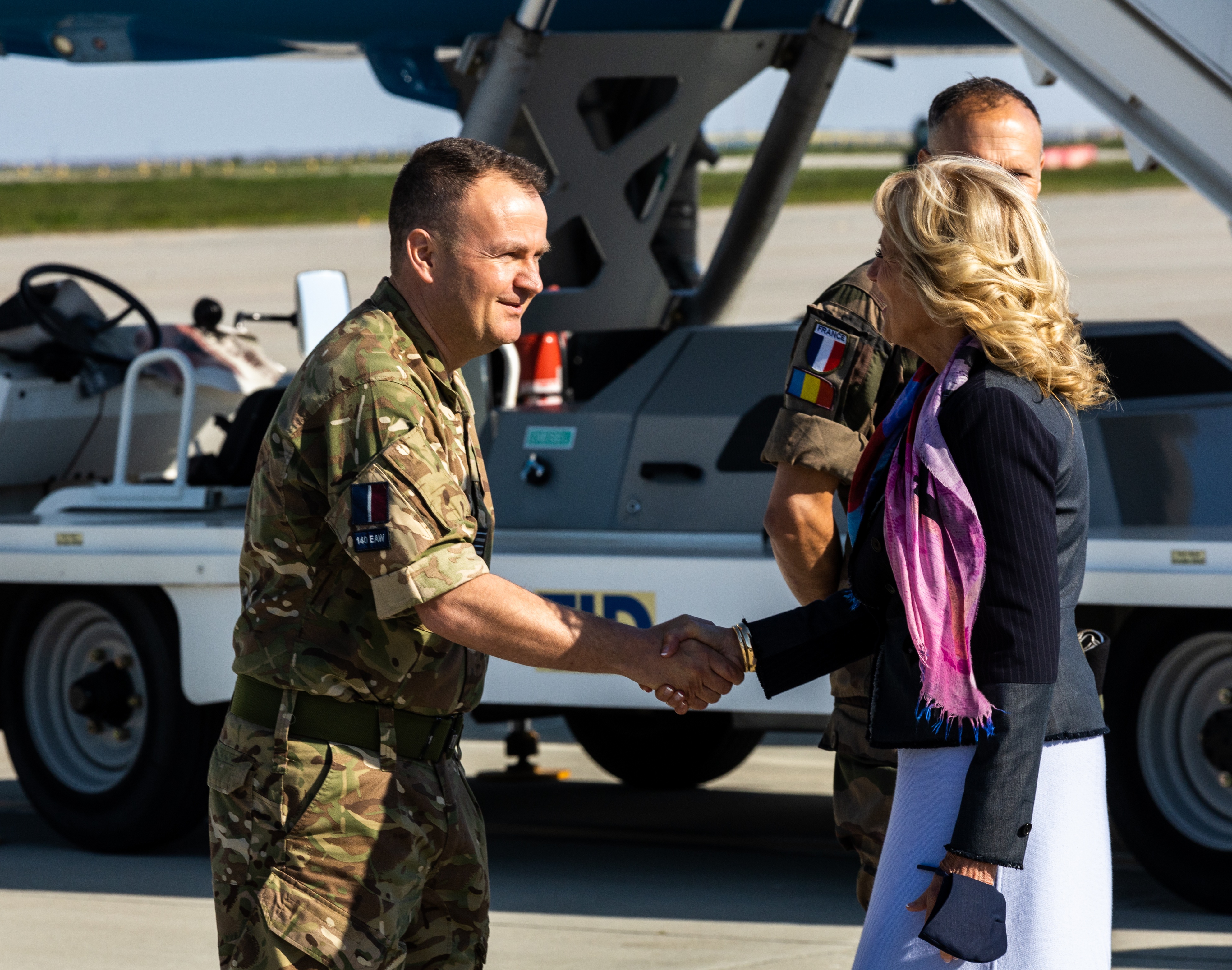 Personnel shakes hands with First Lady.