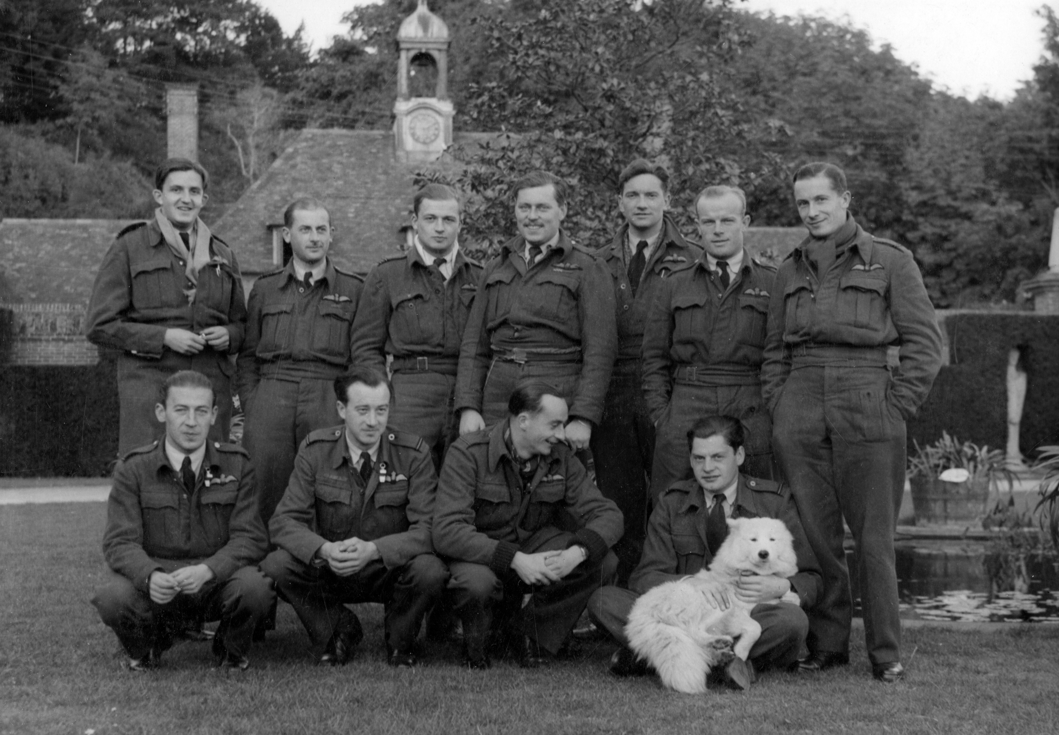 Group photo of Squadron with the dog mascot.